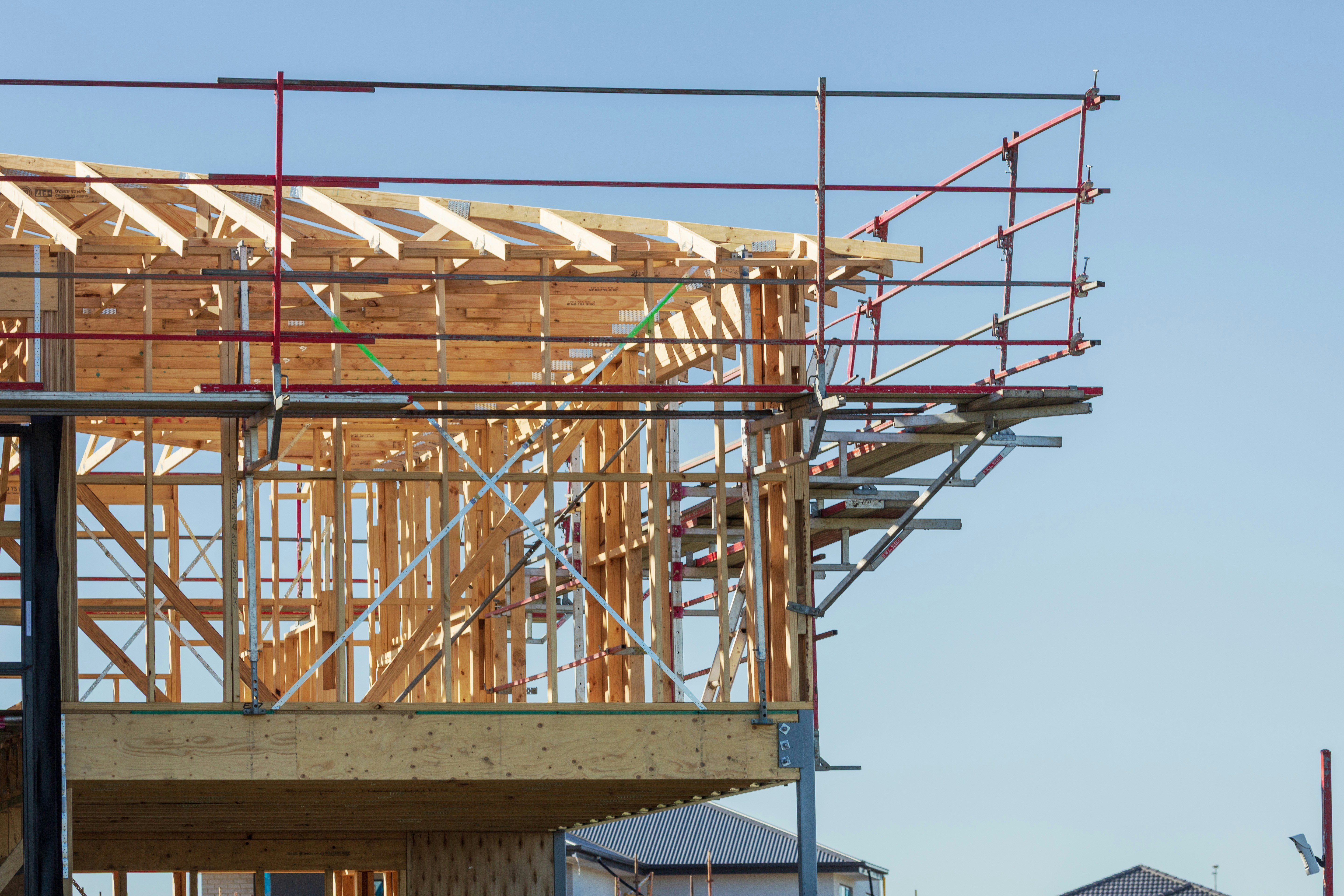 wooden house frame under construction - Wooden frame of a house under construction with scaffolding