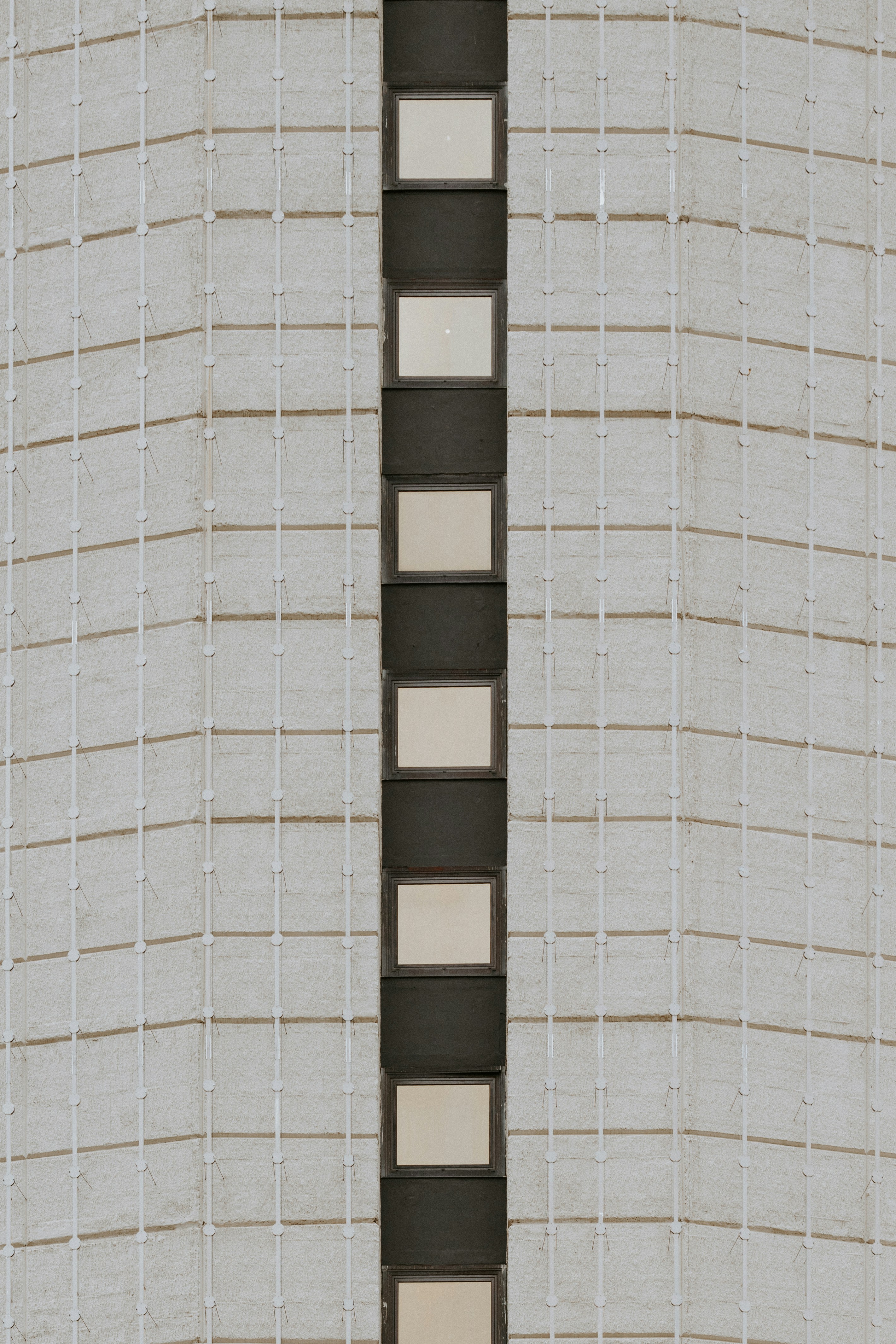 Building facade with vertical windows and grid pattern