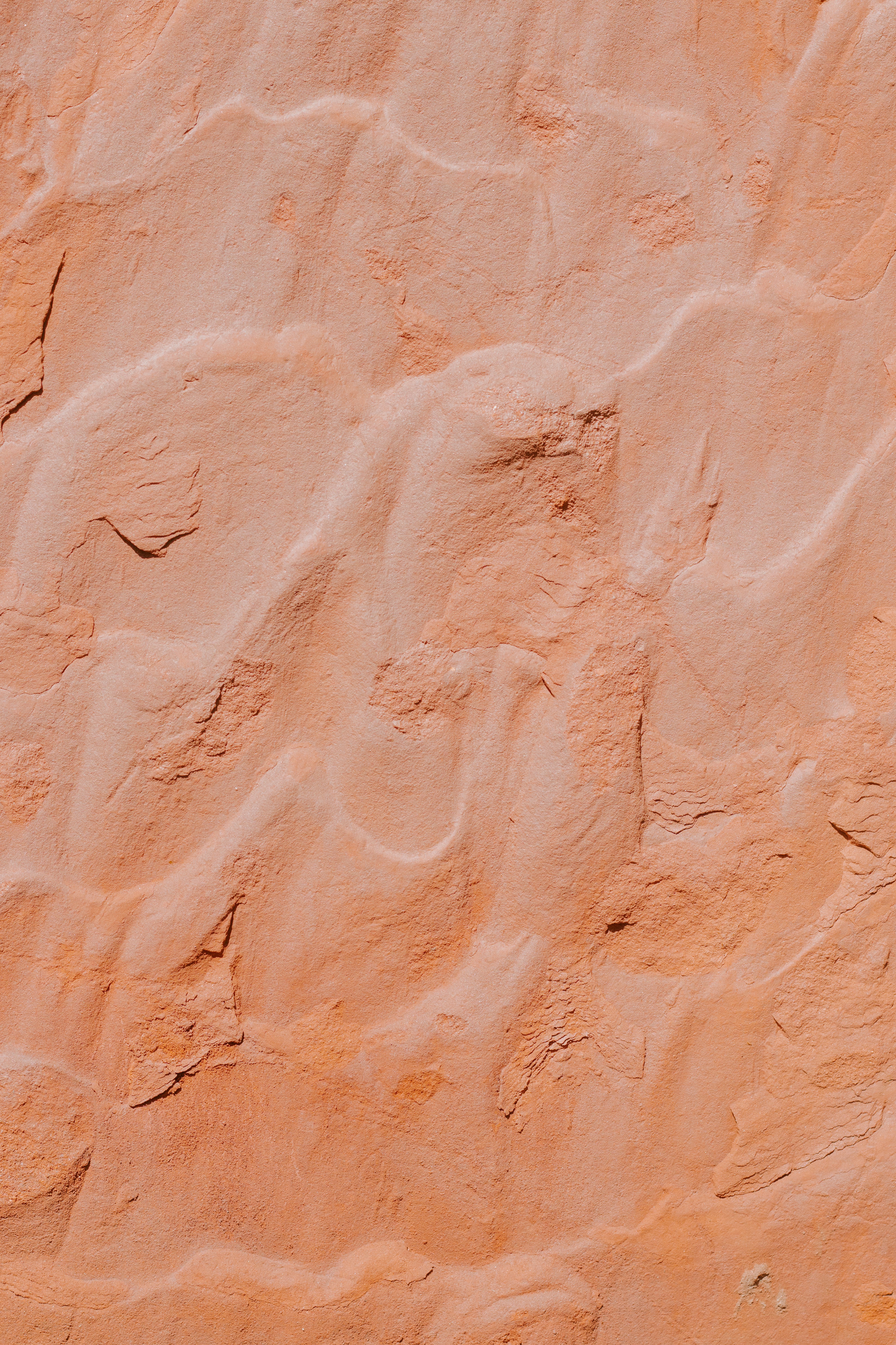 Wavy patterns on orange sandstone texture