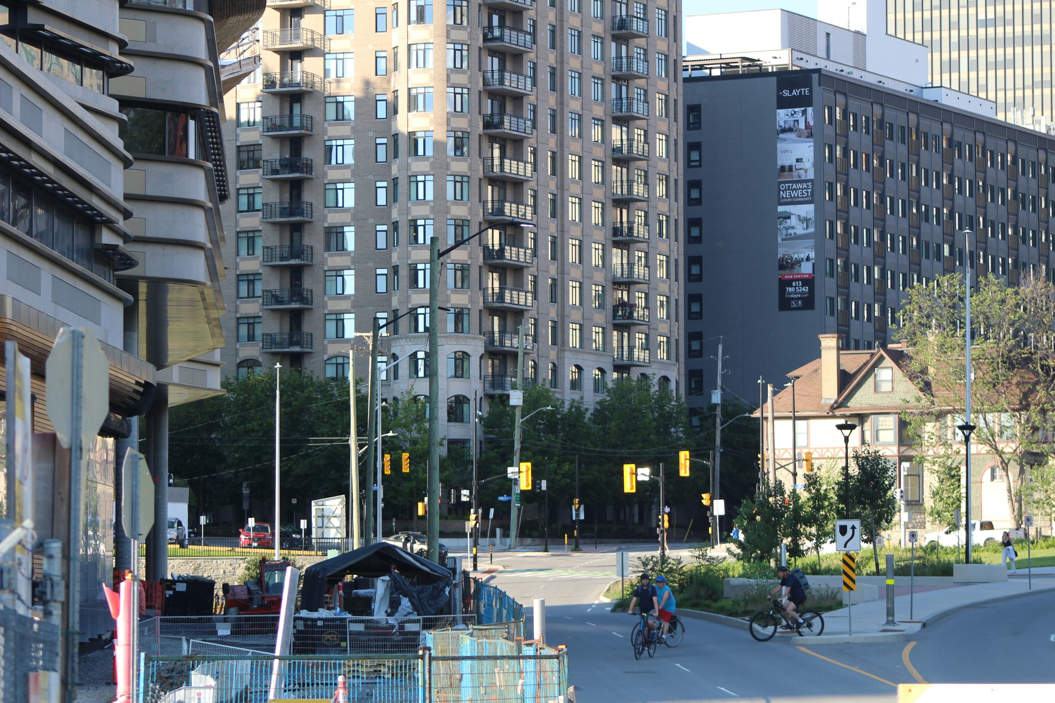 Cyclists on a street among tall apartment buildings