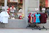 A storefront with canadian souvenirs and clothing racks outside