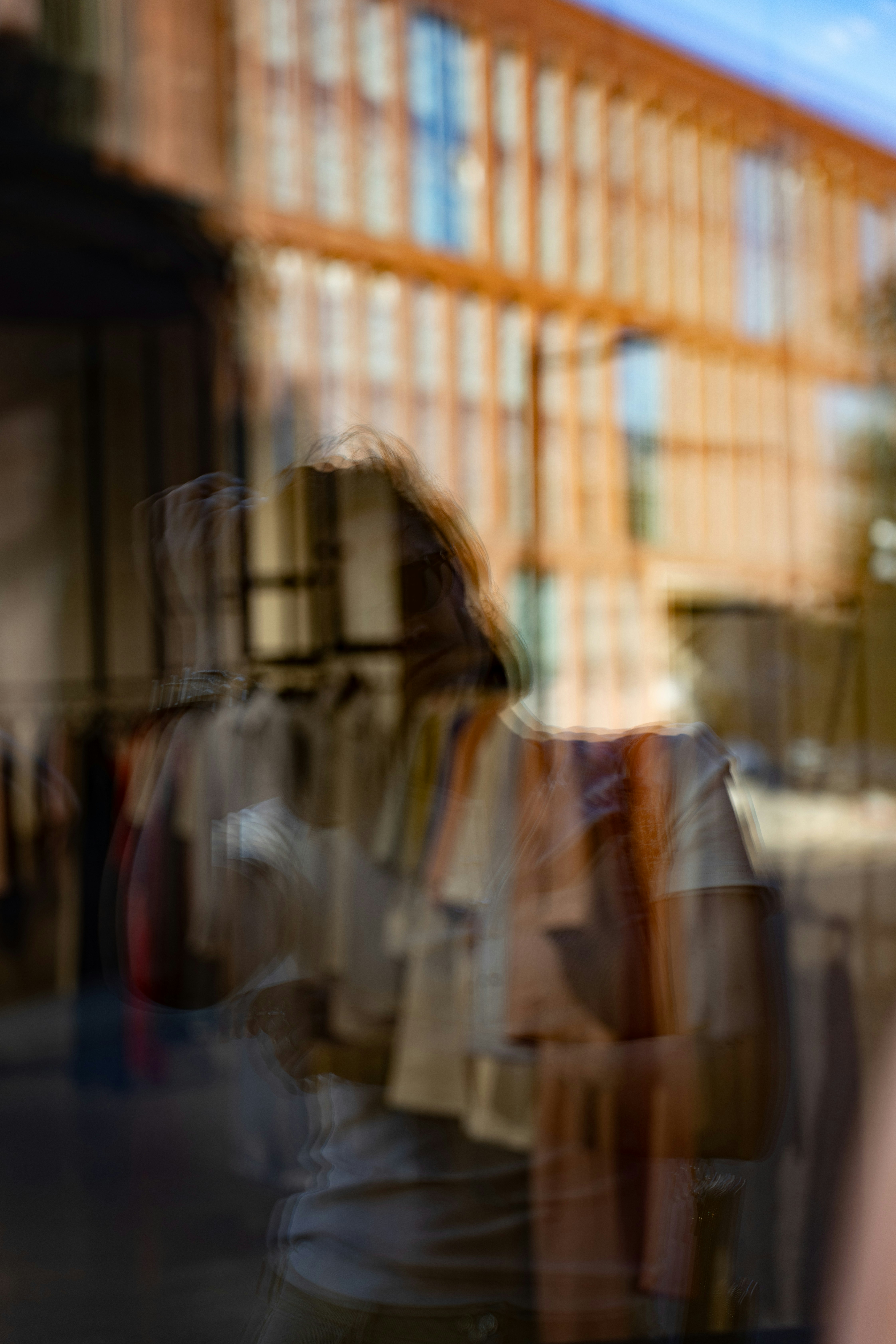 Abstract motion blur of person and building reflection