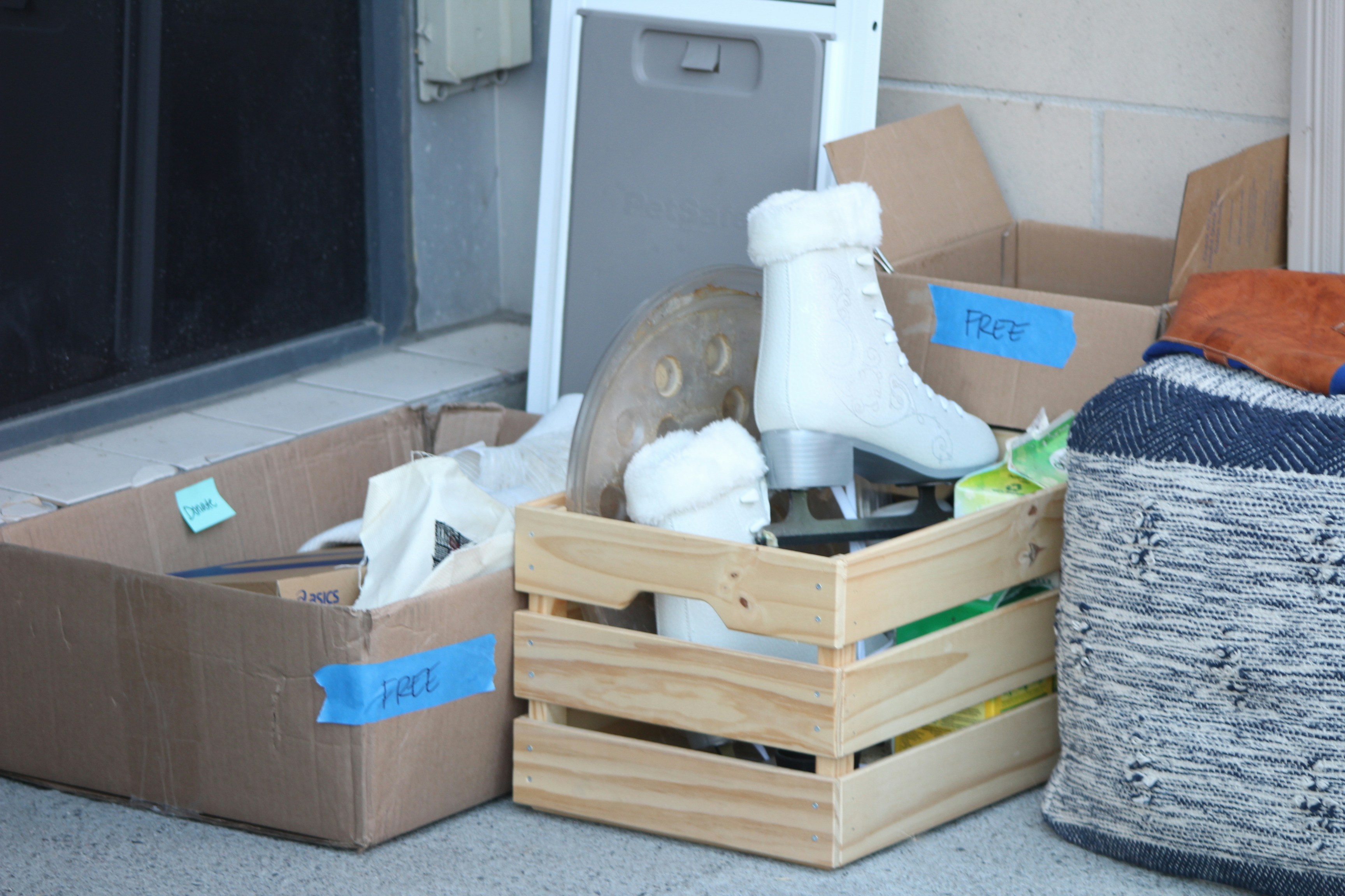 Moving boxes and a wooden crate packed with belongings