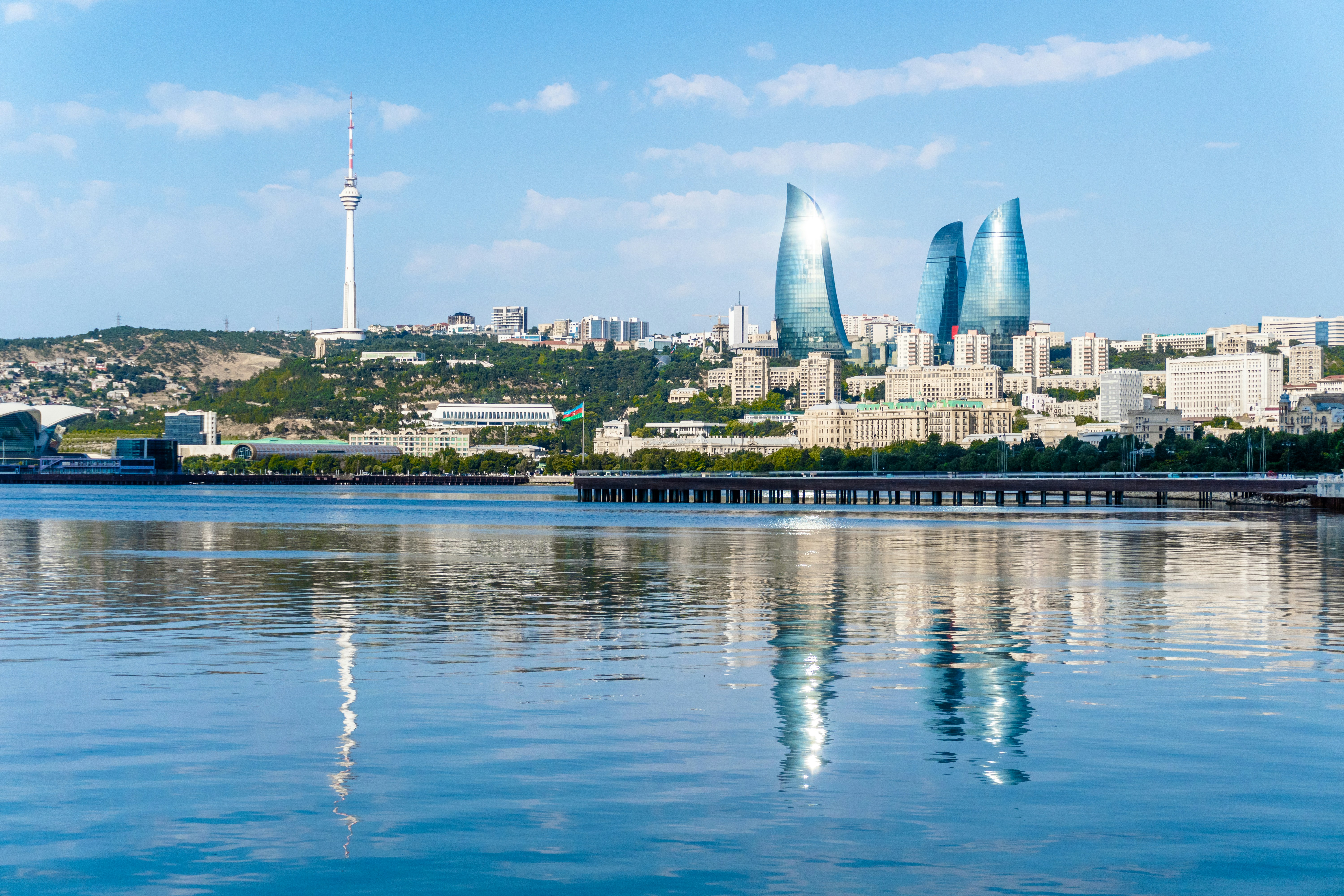 Baku cityscape with flame towers reflecting in calm water