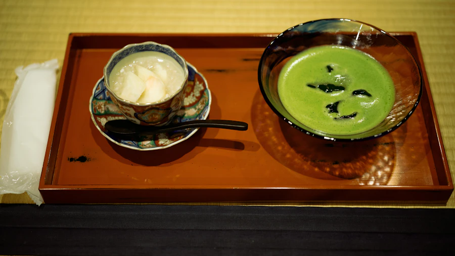 A bowl of matcha and a plate of wagashi sweets on a lacquered tray — the spring sweet service