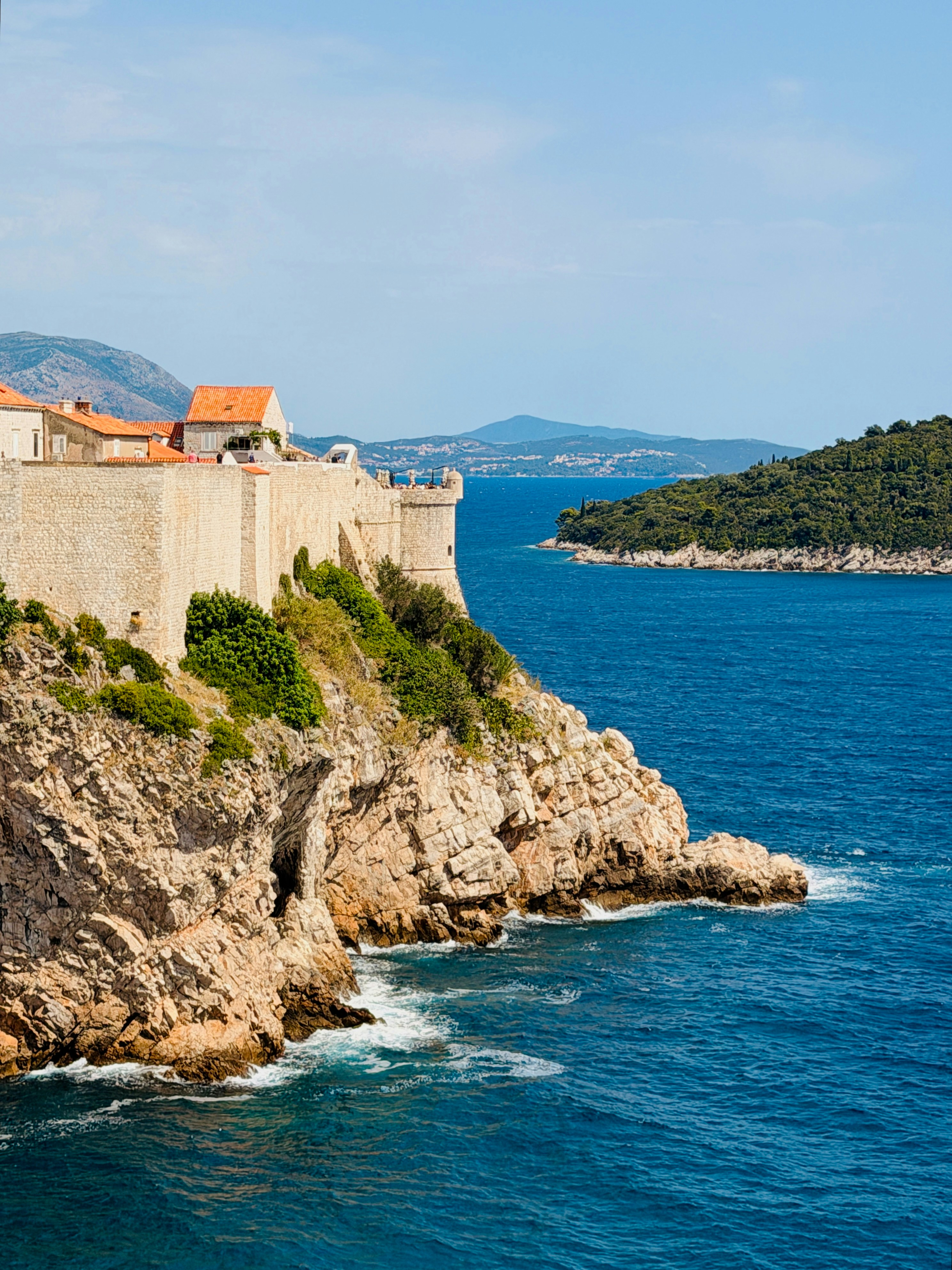 Historic stone walls on a cliff overlooking the sea