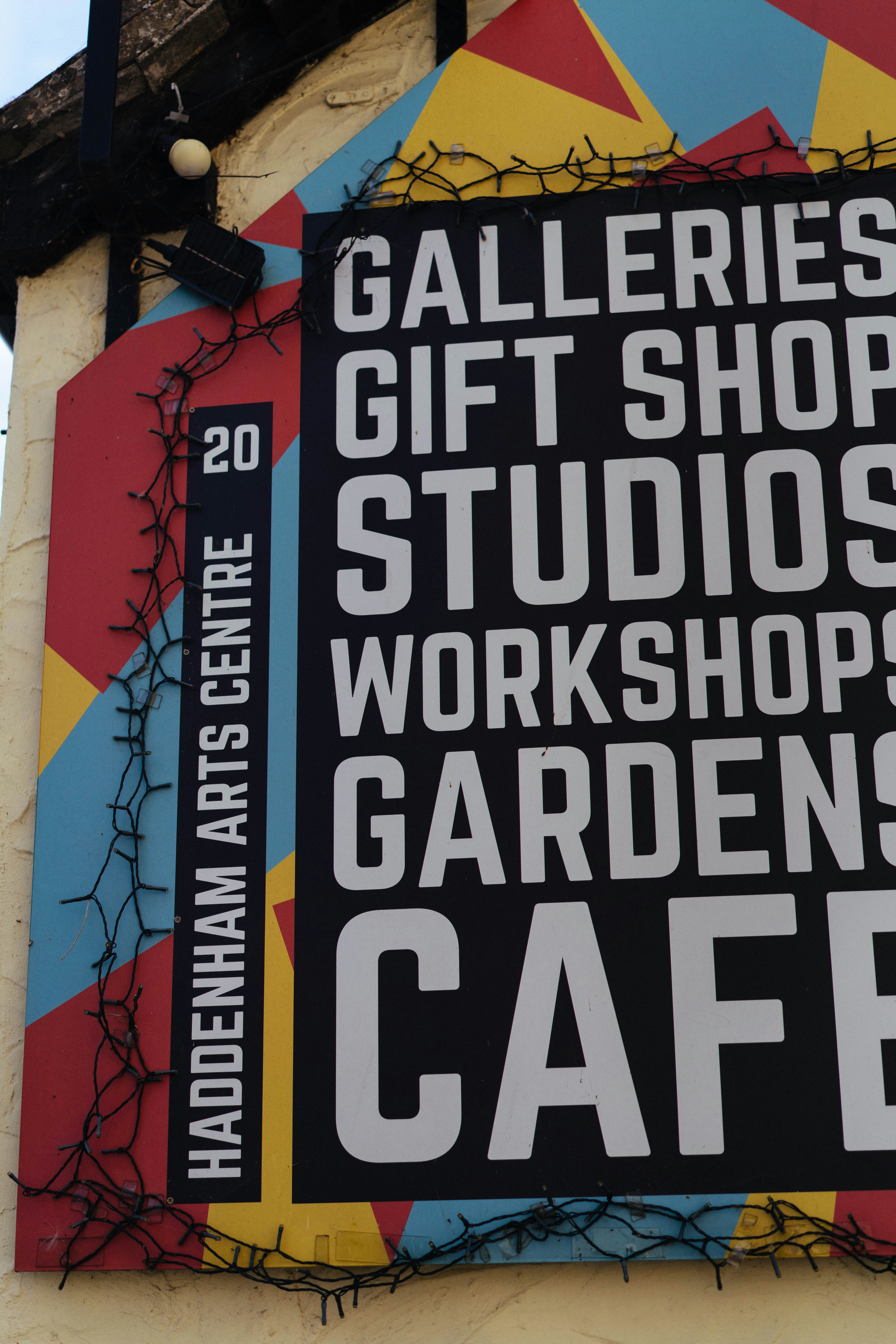 Colorful haddenham arts centre sign with galleries, gift shop, cafe.
