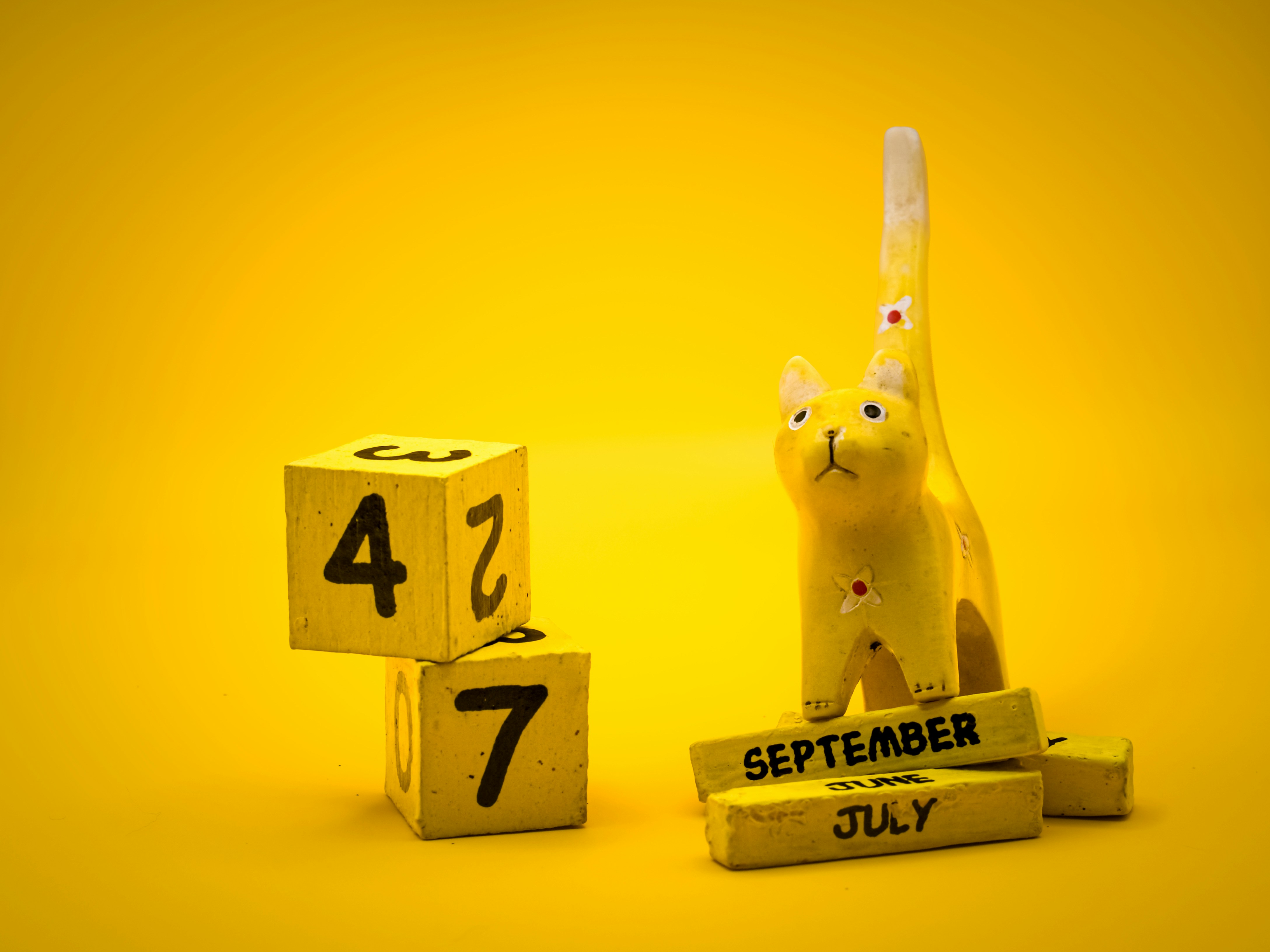 Desk calendar blocks on a bright yellow background