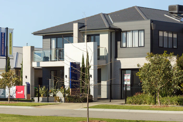 Coastal-style home with timber accents and a light facade.