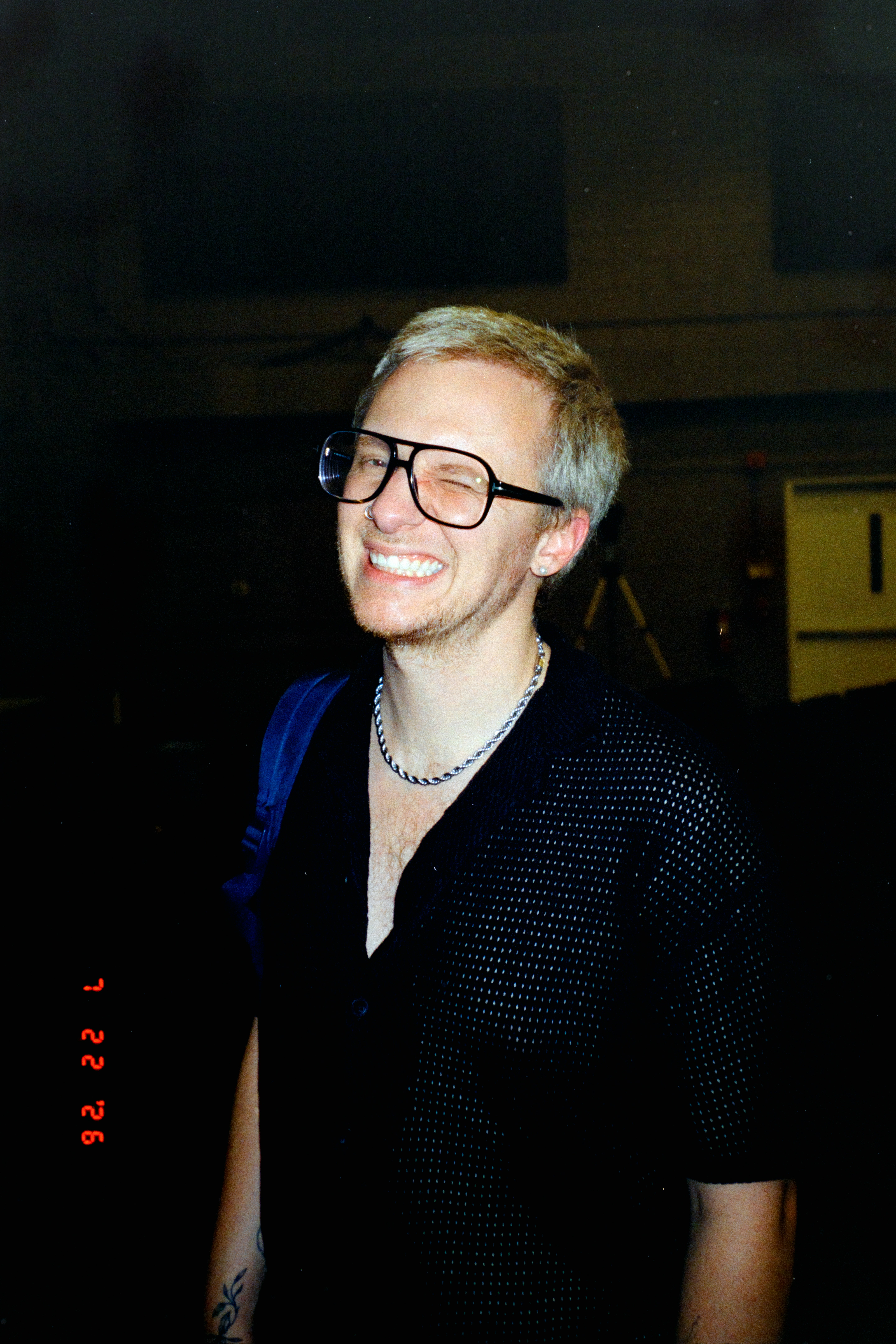 Blond man with glasses smiling broadly