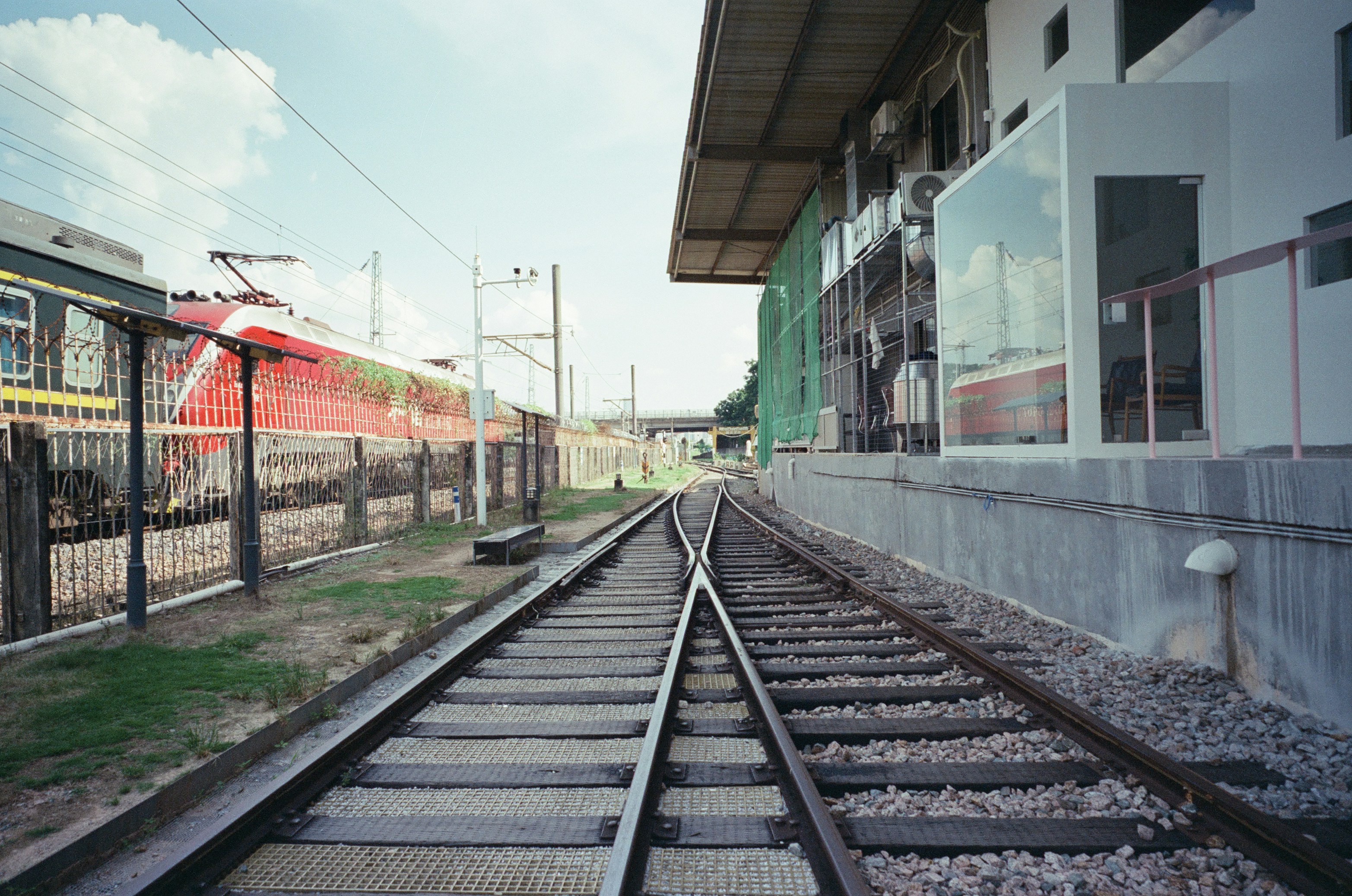Tracks diverging at a station platform with a train waiting
