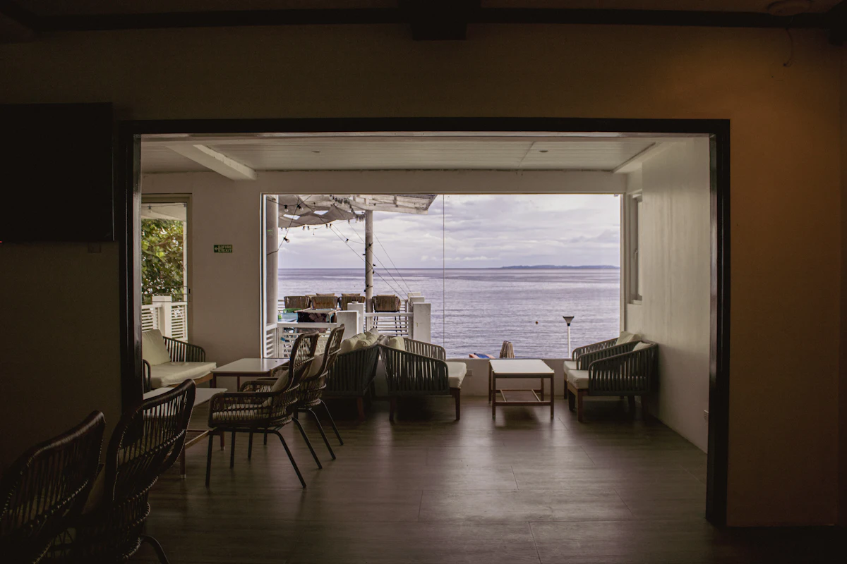 Interior open to a sea view. Illustrative editorial image, not a photograph of Cliff Pavilion.