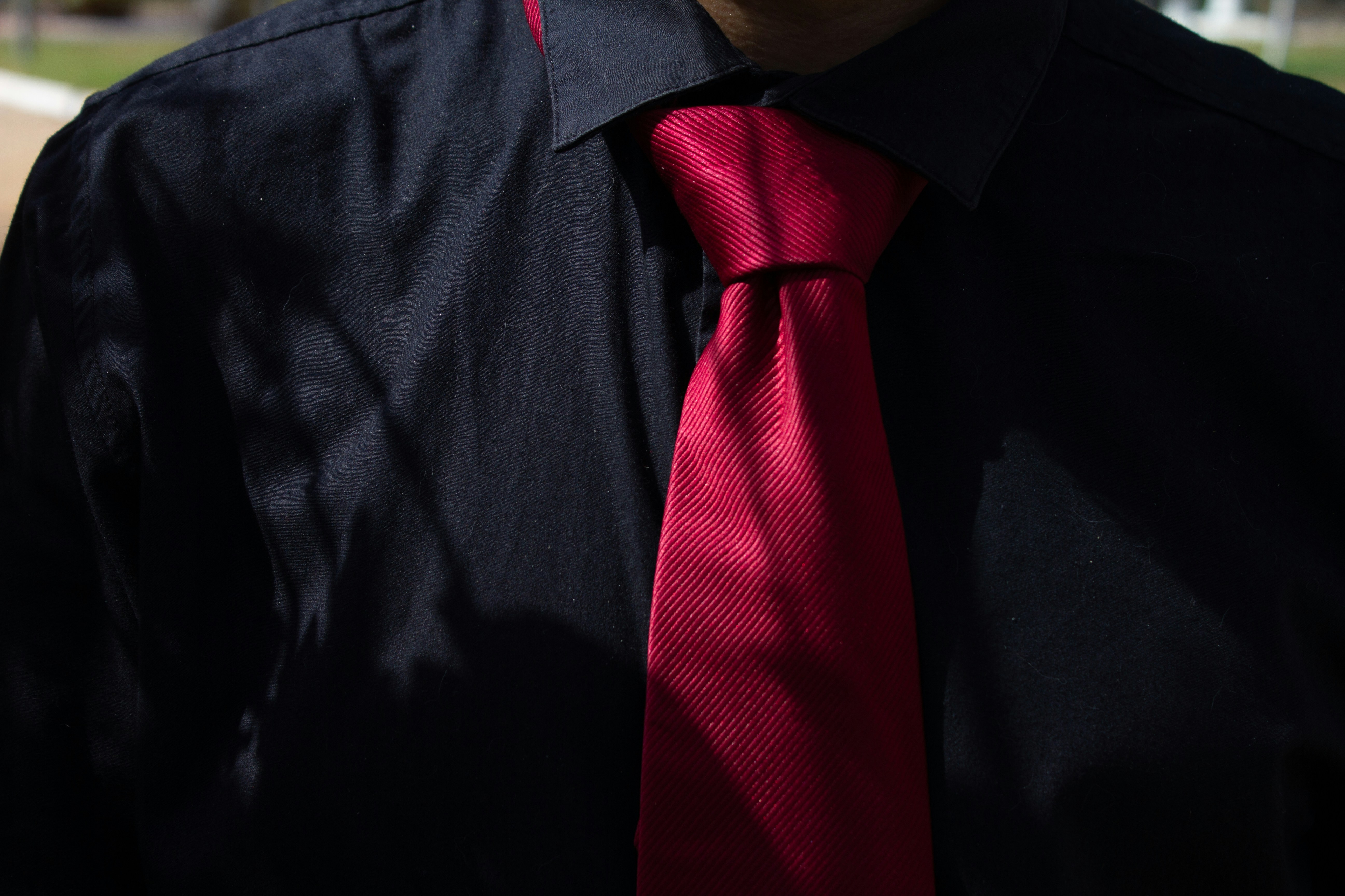 Dark blue shirt with a vibrant red tie