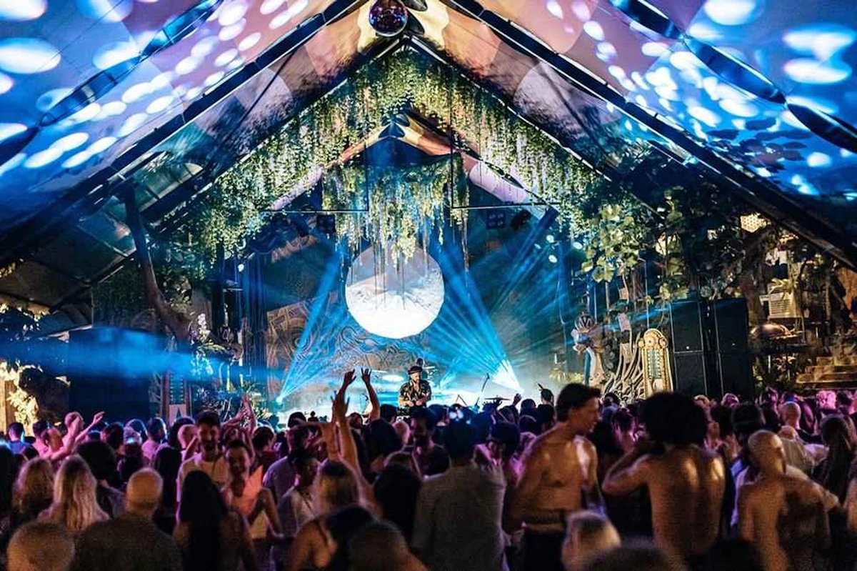 Crowd dancing under vivid festival lights