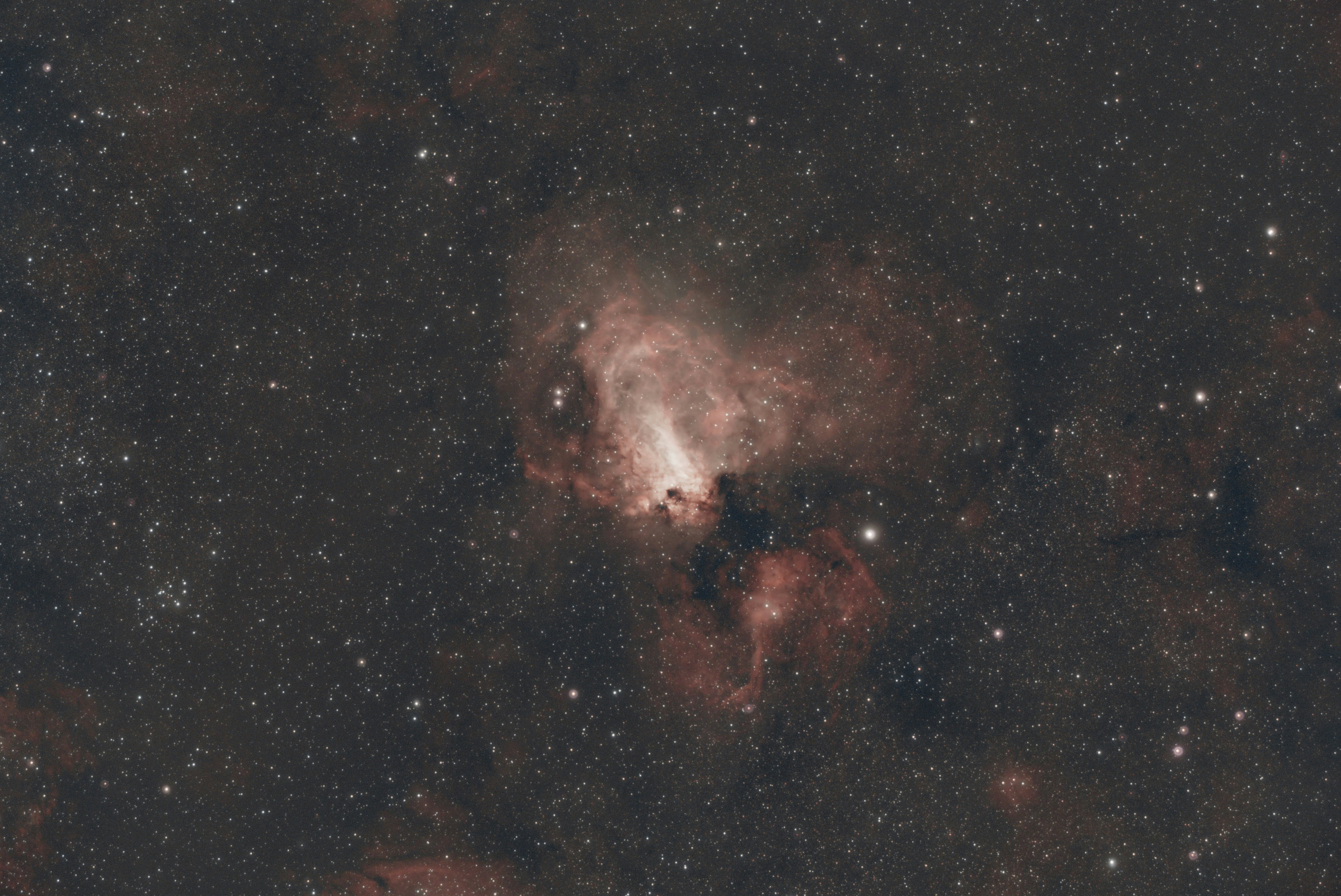A luminous nebula surrounded by numerous stars in deep space