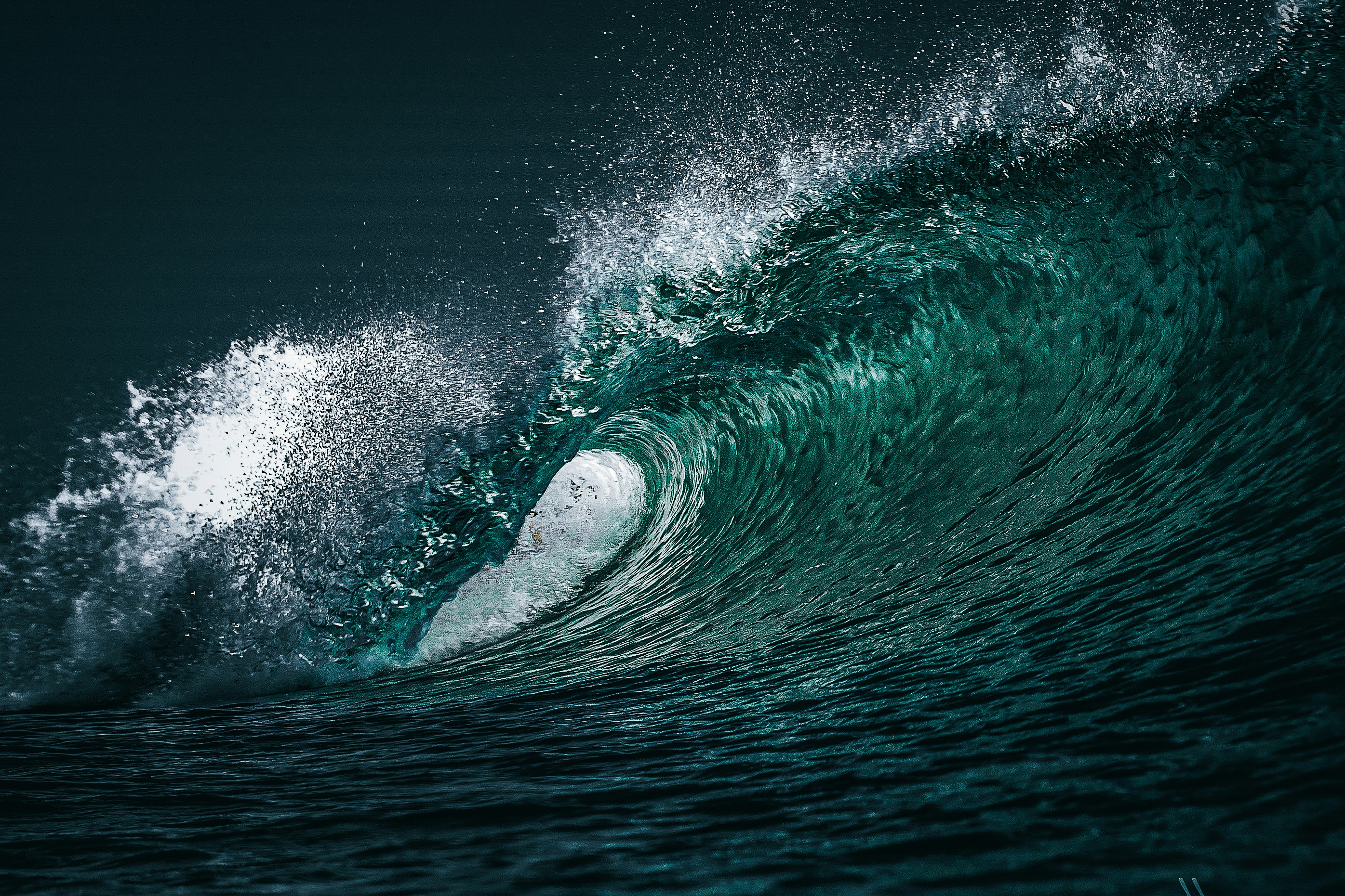 A powerful ocean wave with green water and white spray
