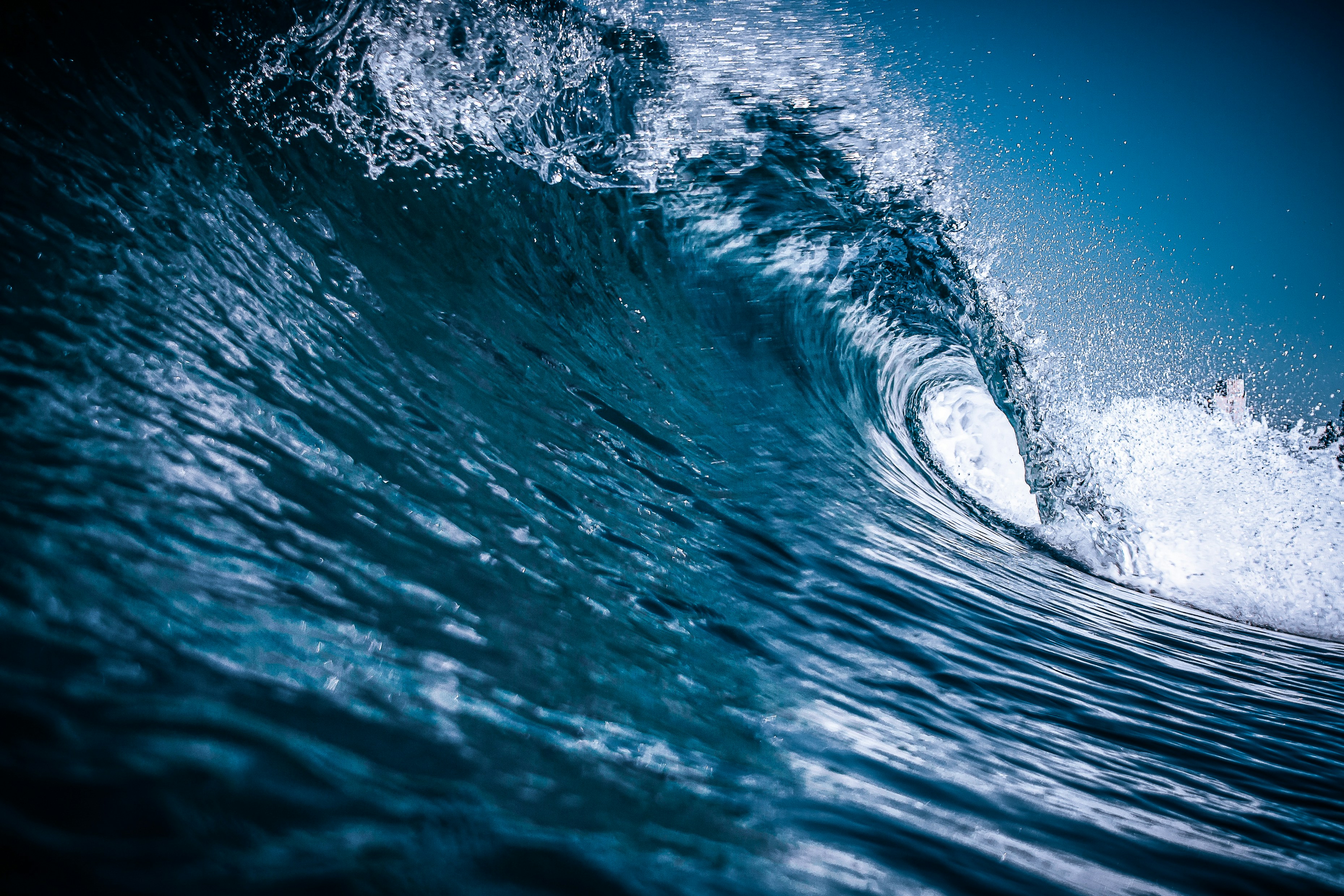 A powerful blue ocean wave curling with white foam