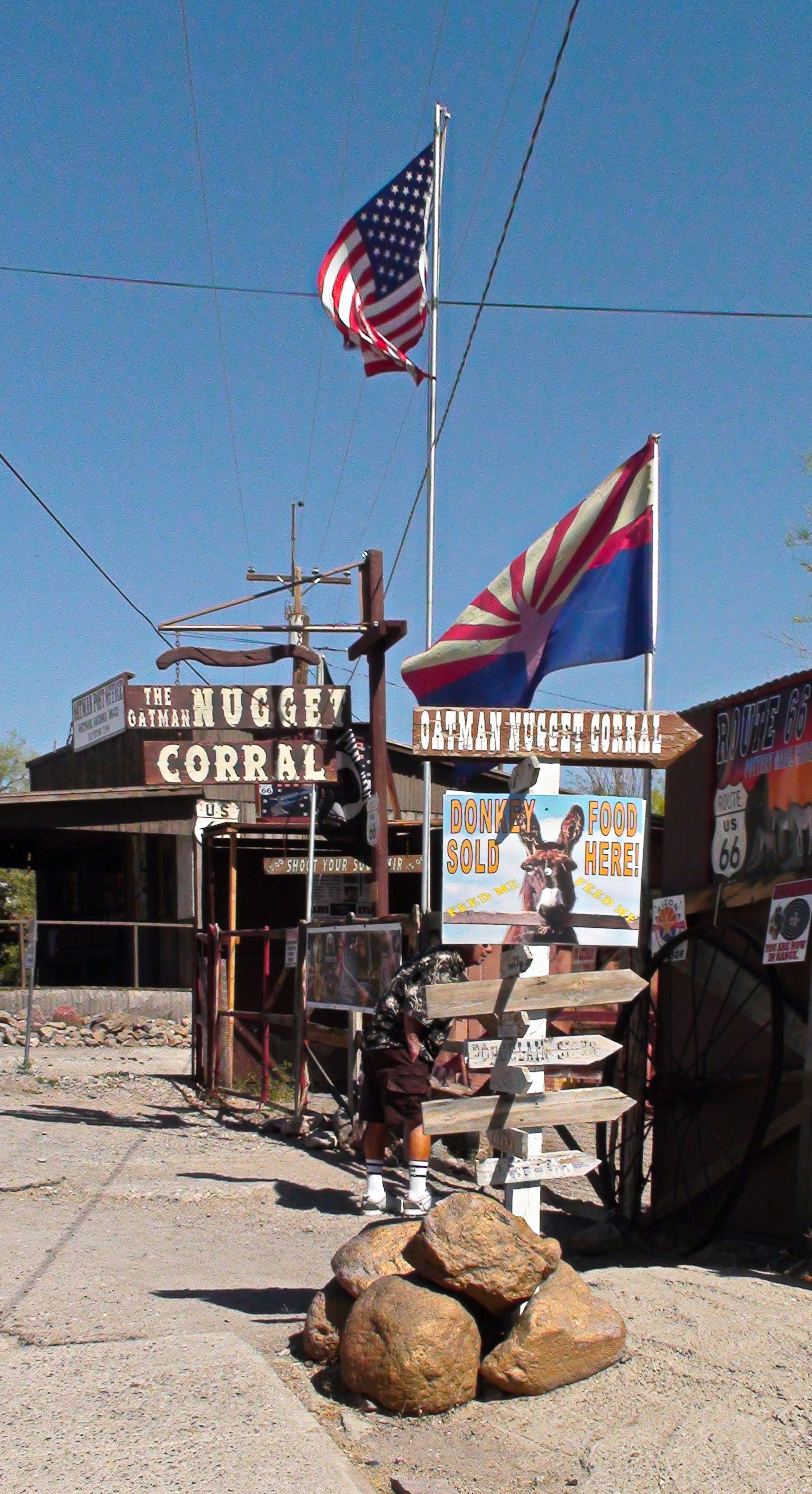 American and arizona flags fly over the nugget corral entrance.