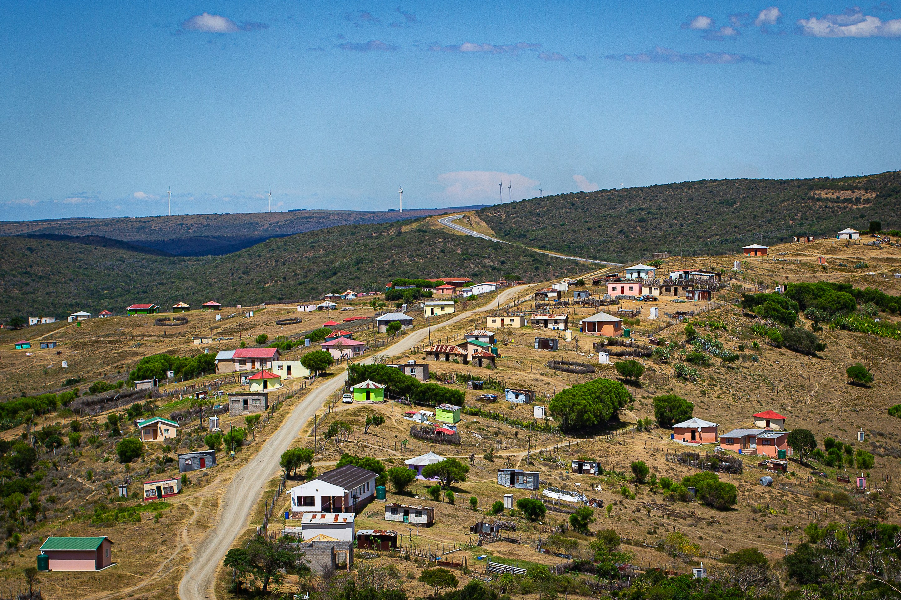 Scattered houses in a rural village on dry, rolling hills