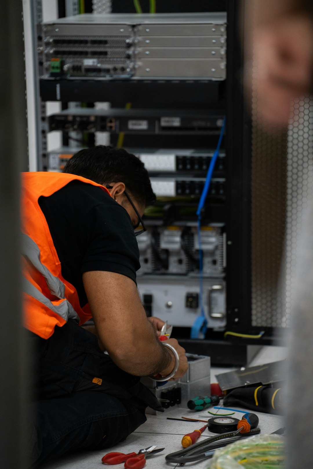 Technician maintaining production server equipment, the physical picture of software maintenance