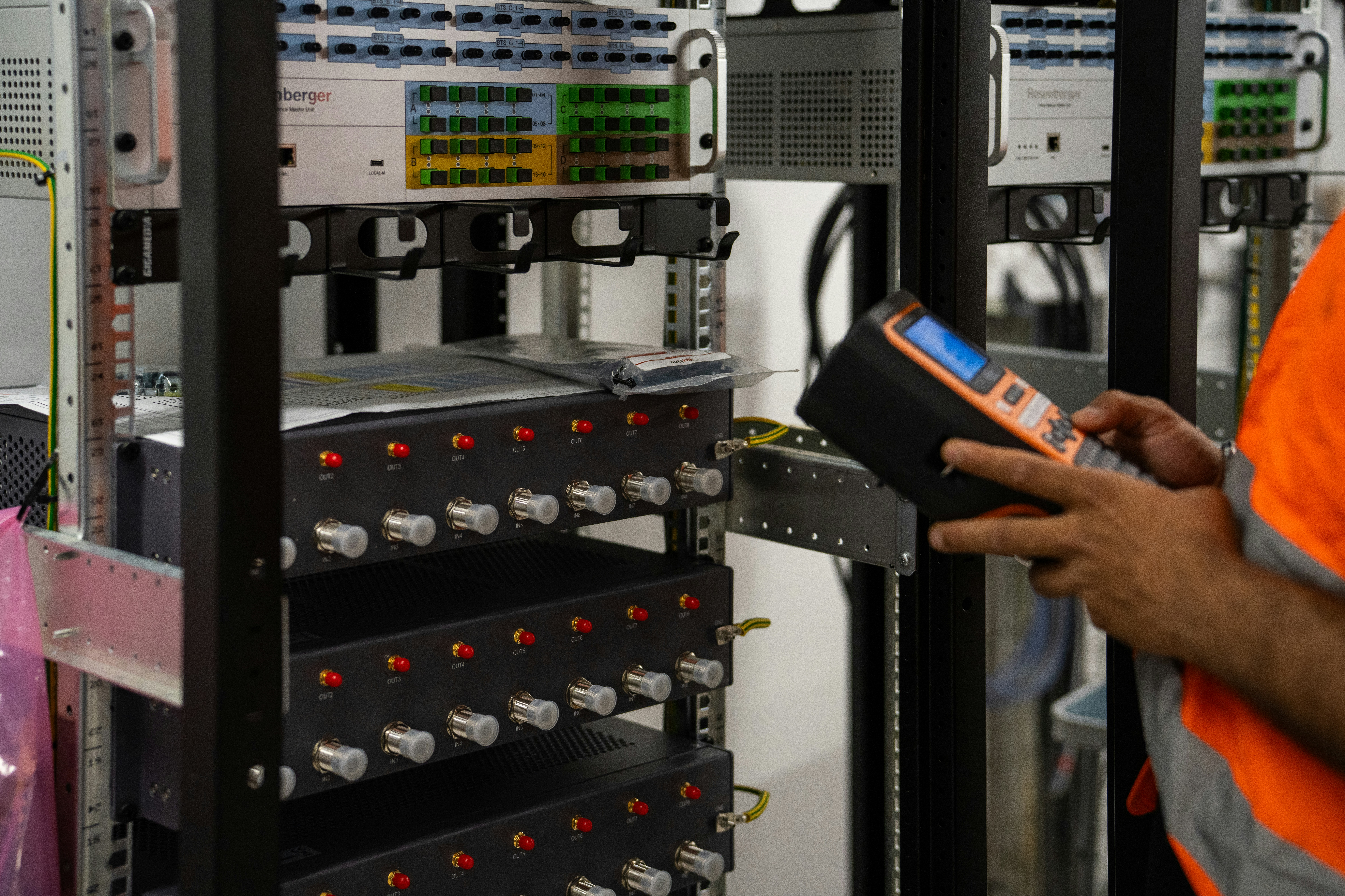 robotic gripper inserting fiber optic cable connector into server