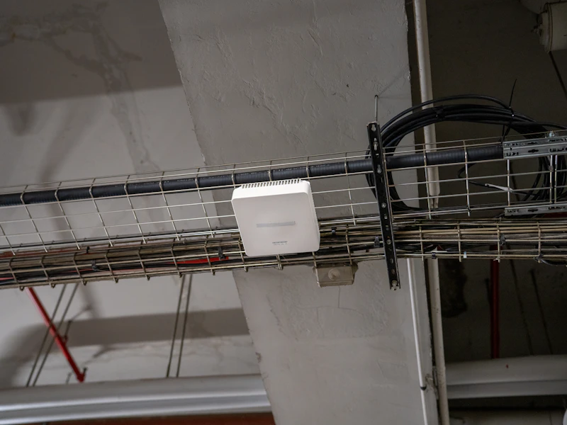 White Wi-Fi access point mounted on a cable tray