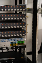Server rack filled with network and electronic equipment.