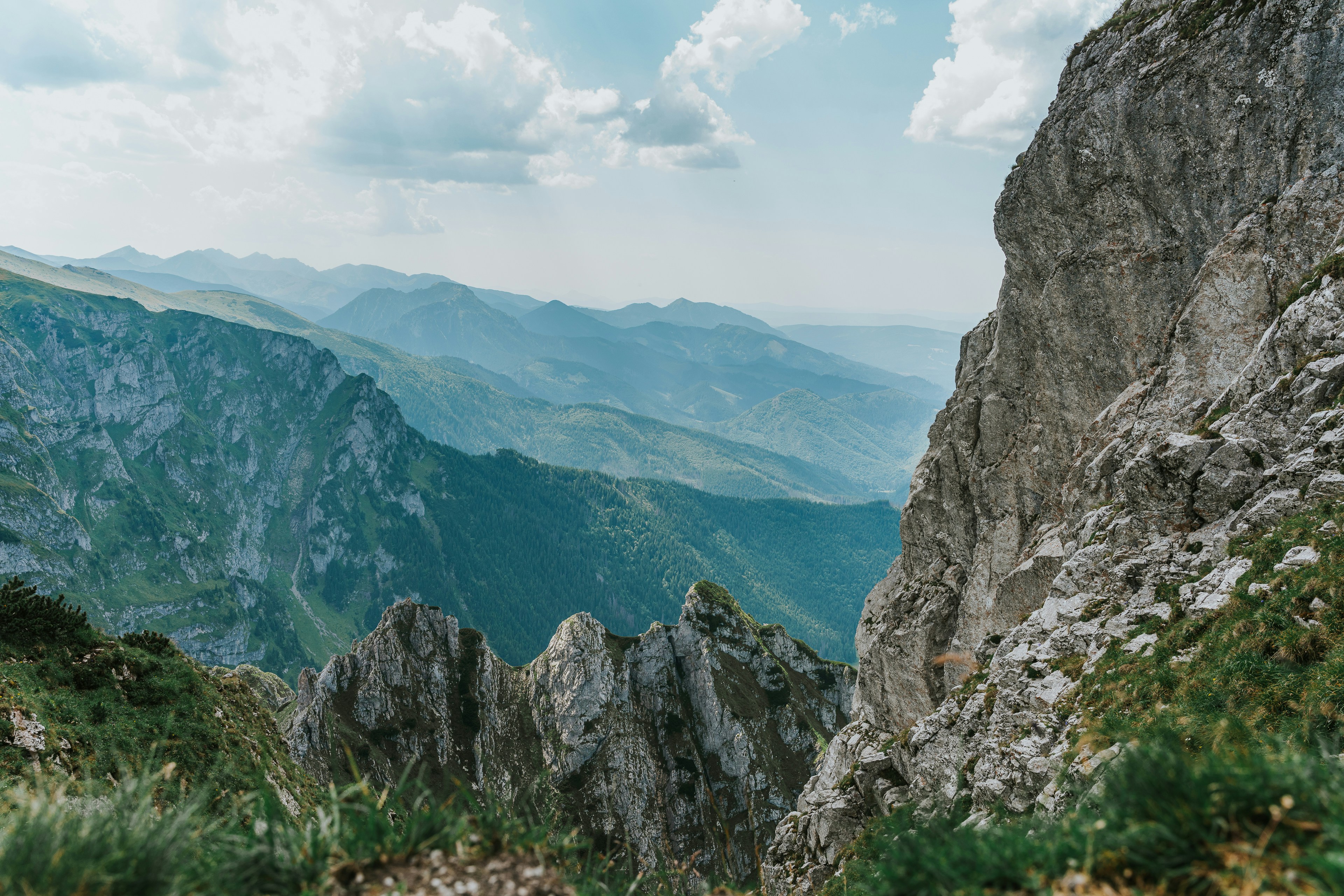 Rugged mountain peaks and valleys under a cloudy sky.
