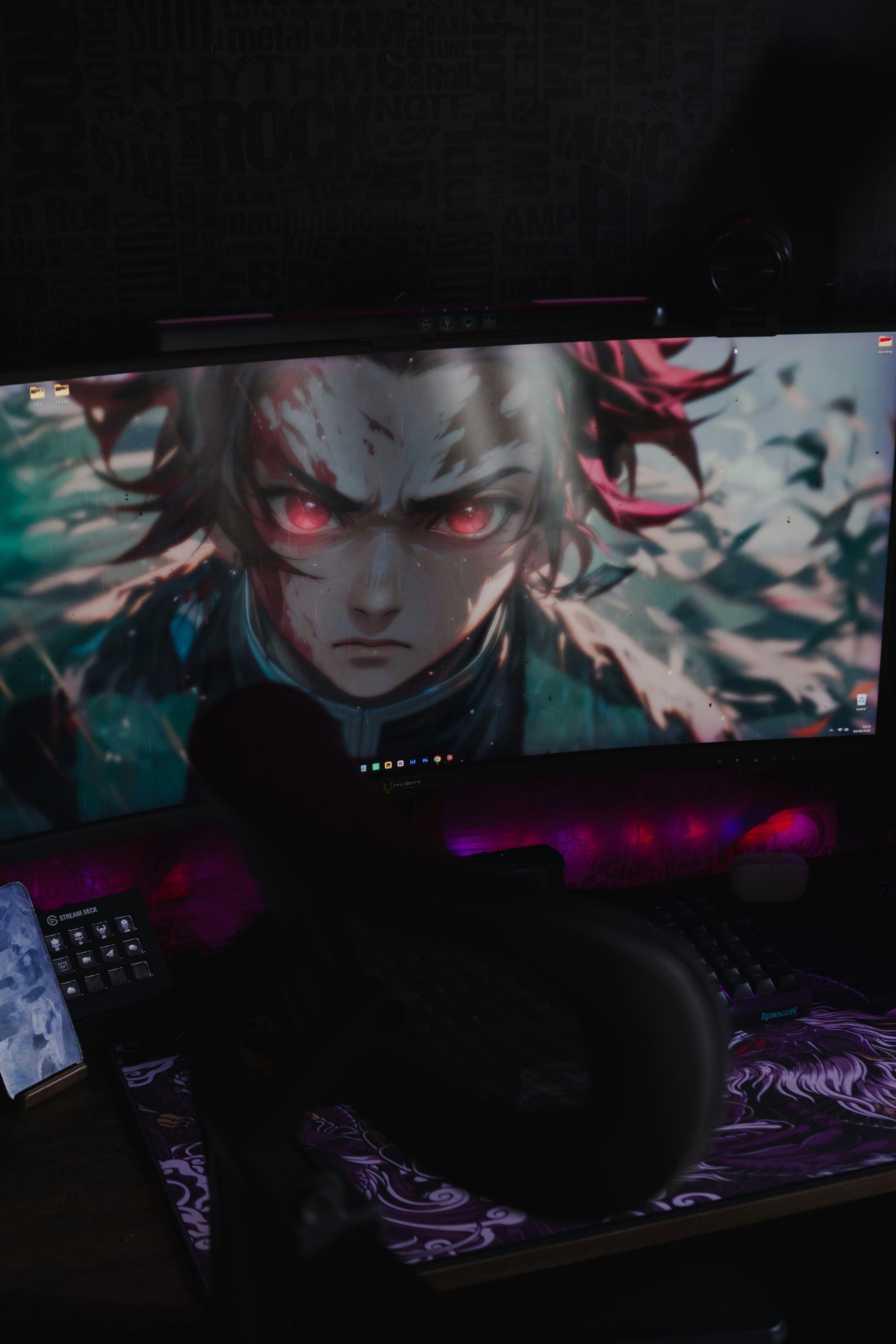 Computer monitor displays an anime character with glowing red eyes.