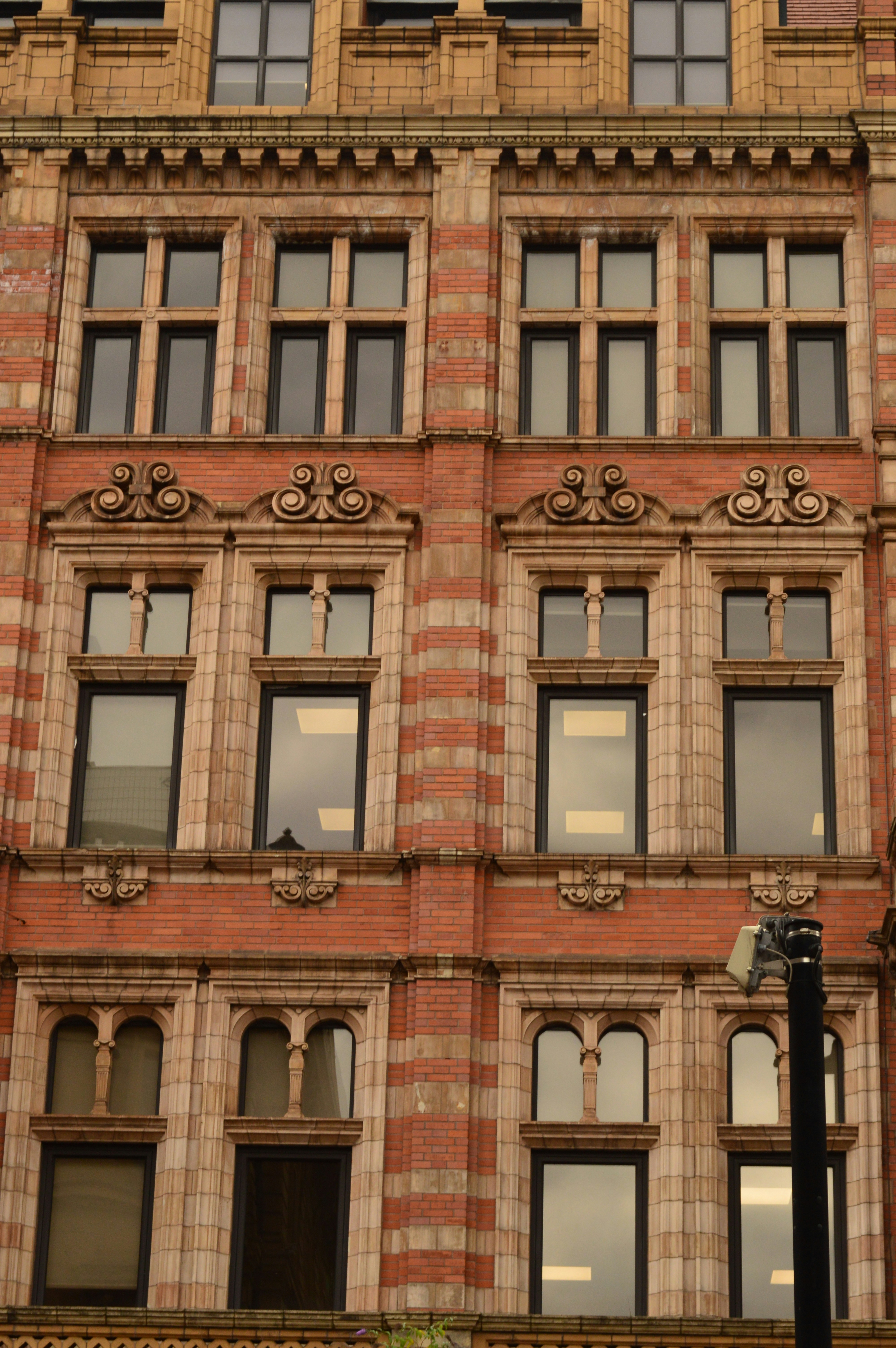 Ornate brick building facade with many windows and decorative details
