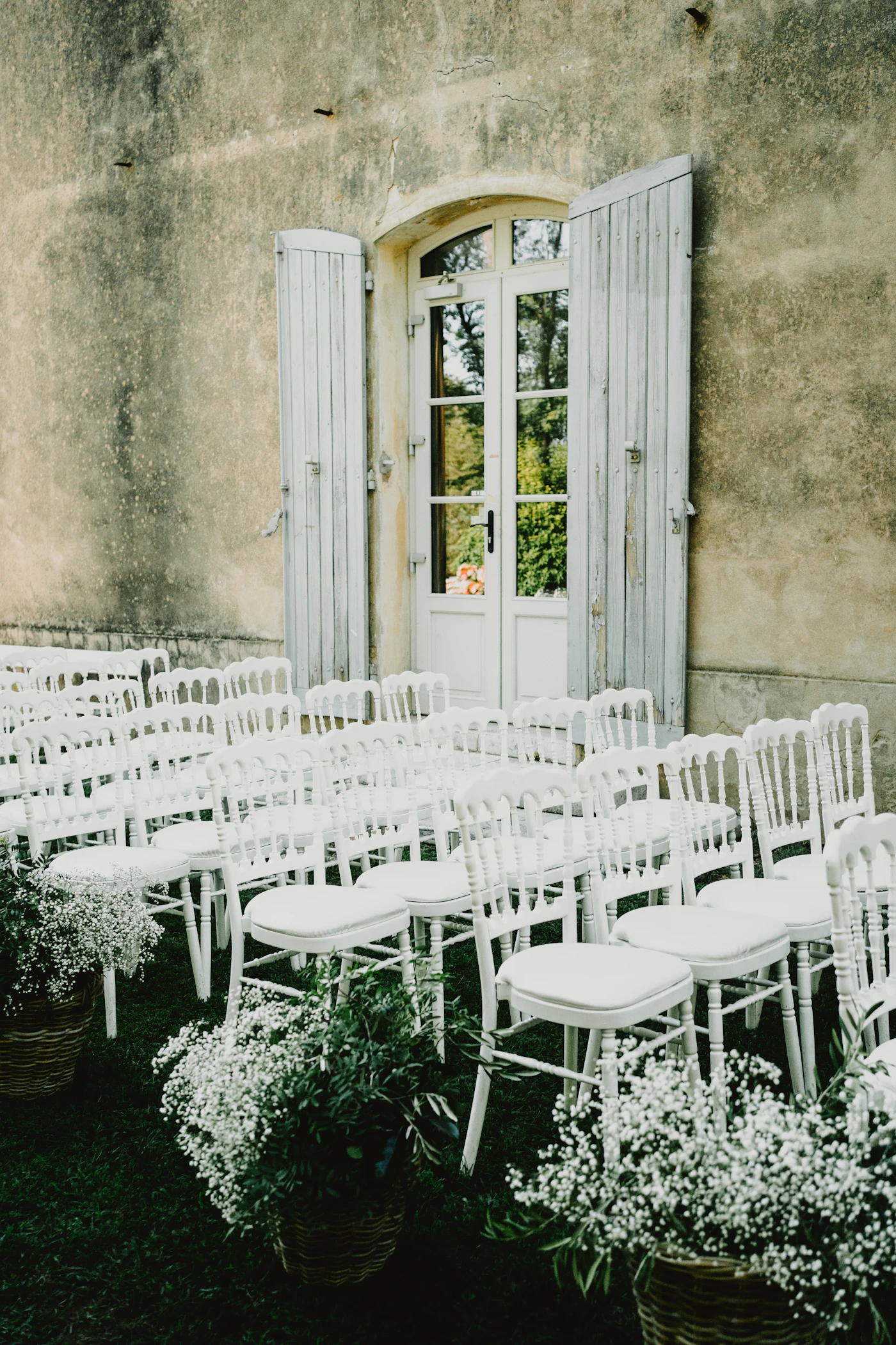 How to plan a wedding on $10,000 budget — A bride holding a simple seasonal flower bouquet.