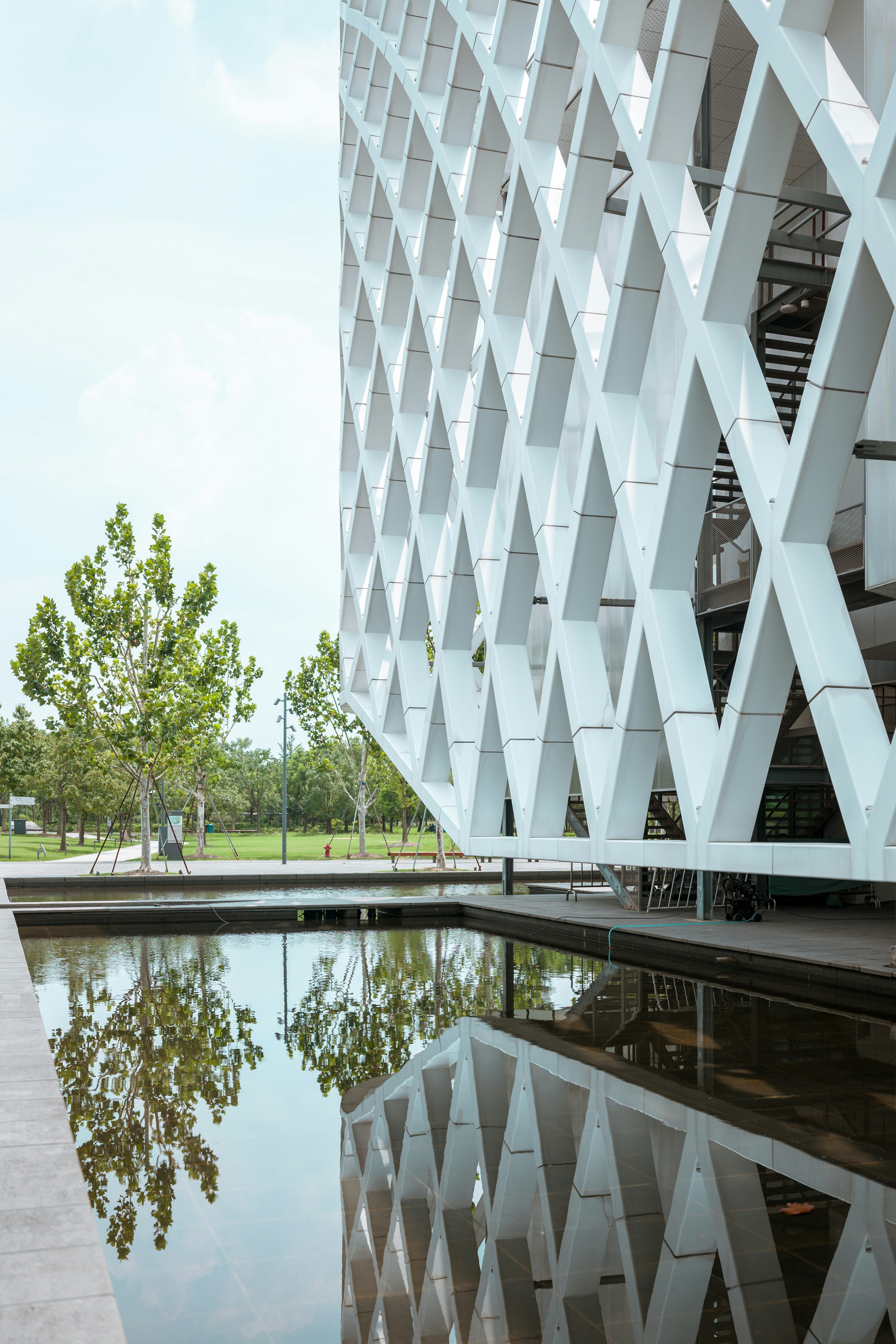 White diamond-pattern building reflected in calm water