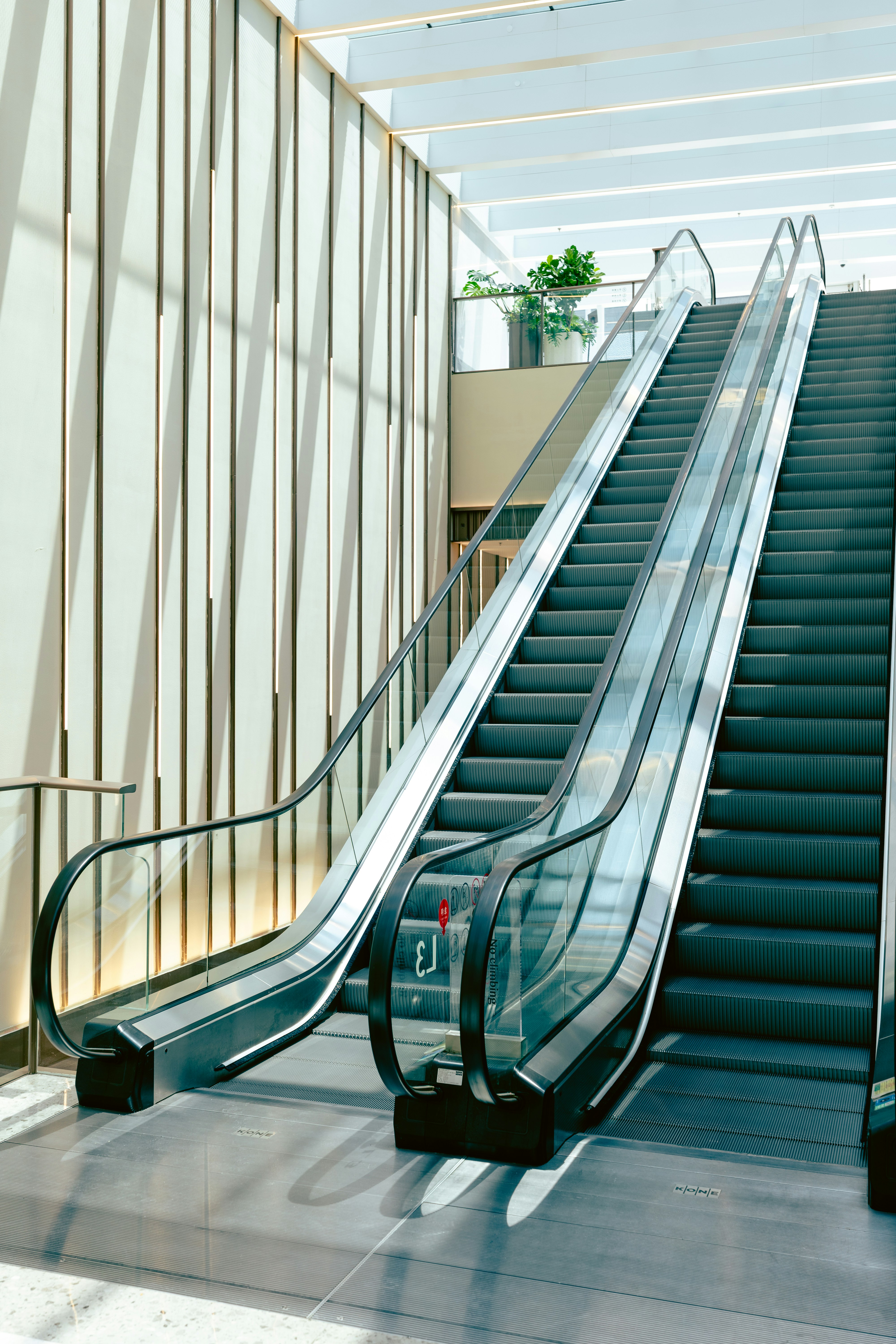 Modern escalators inside a building with natural light