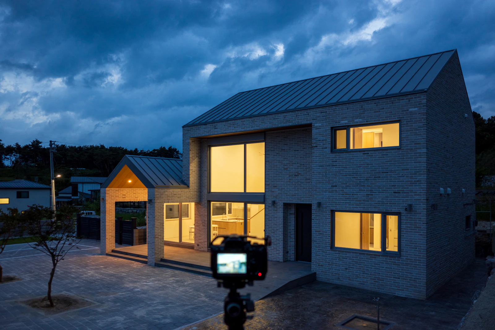 Modern home at dusk with warm lit windows
