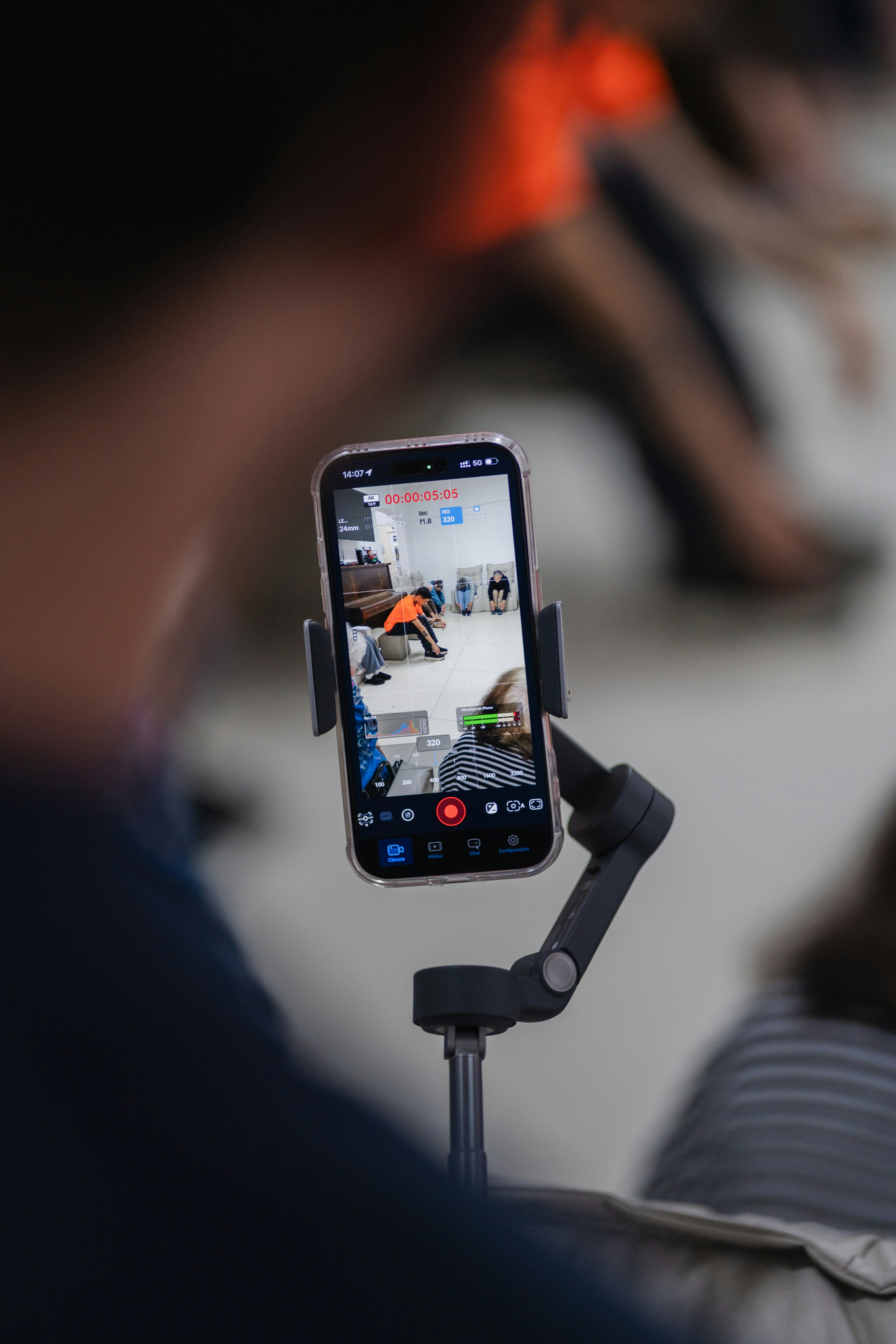 Person recording a live video on a smartphone.