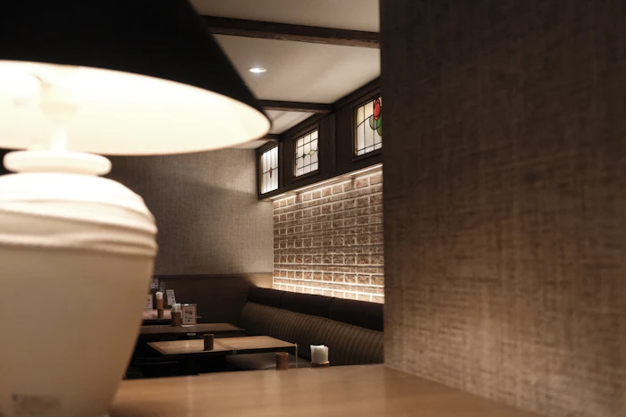 A dimly lit restaurant interior with a decorative lamp