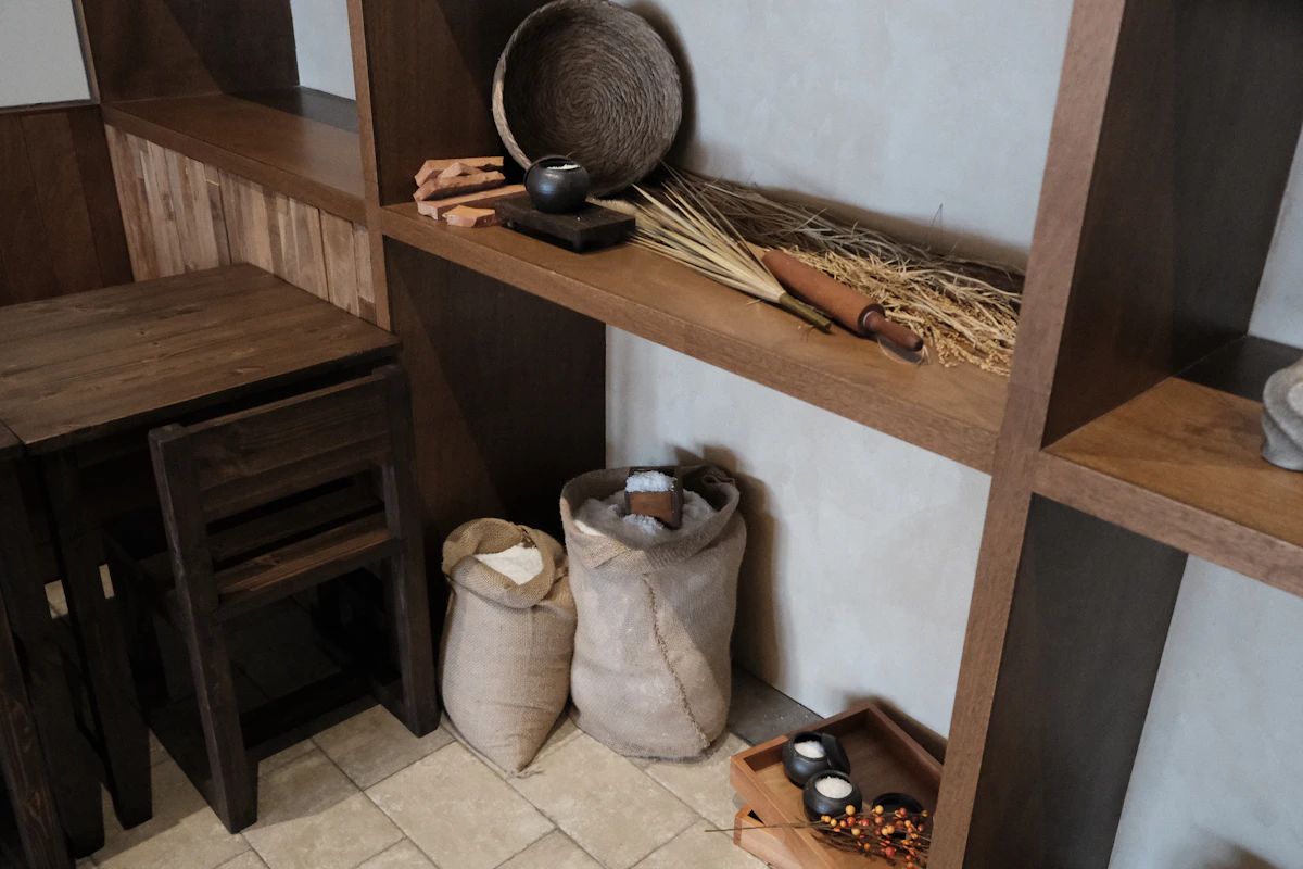 Labelled baskets organising a small kitchen pantry shelf