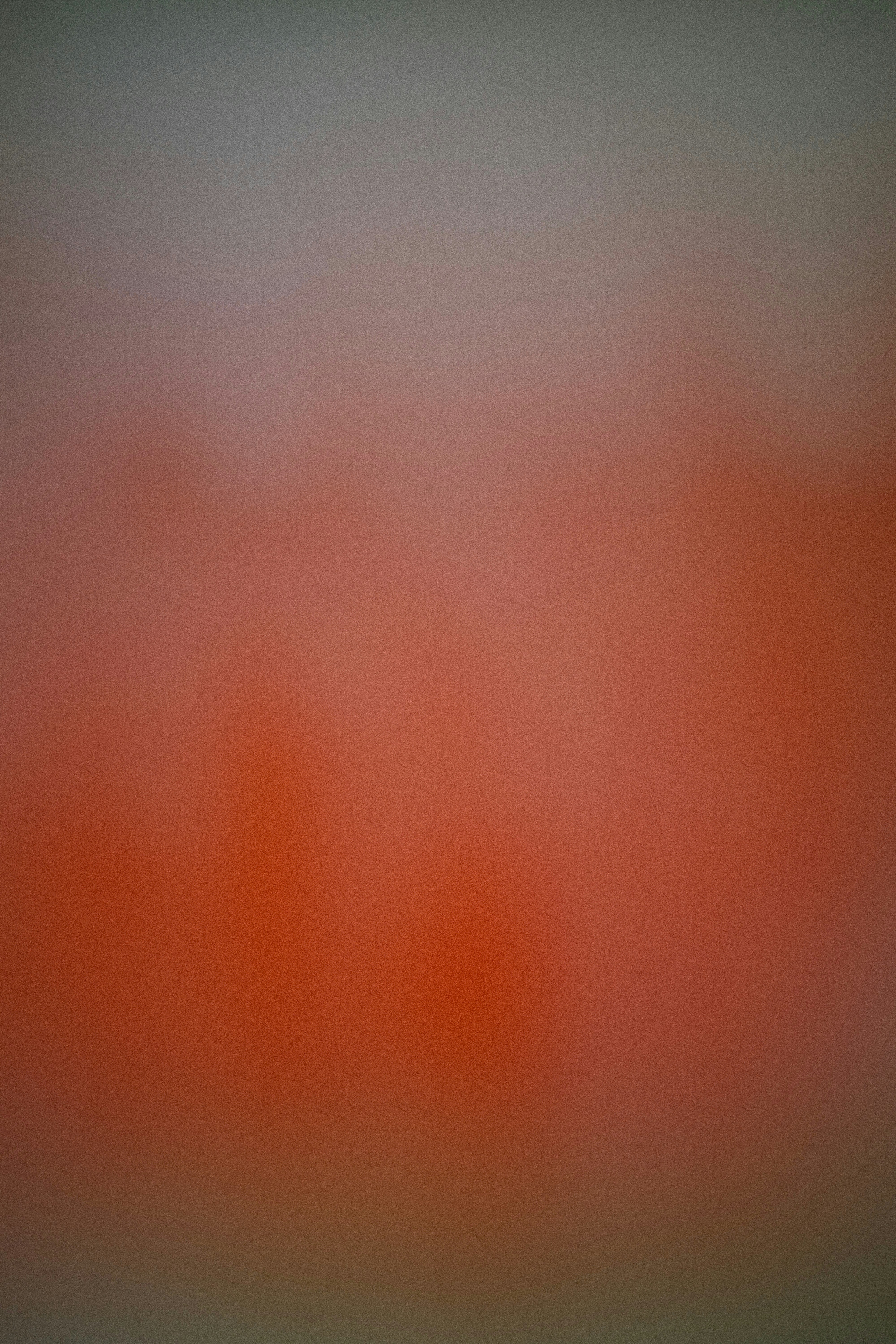 A blurred gradient background transitioning from red to gray.