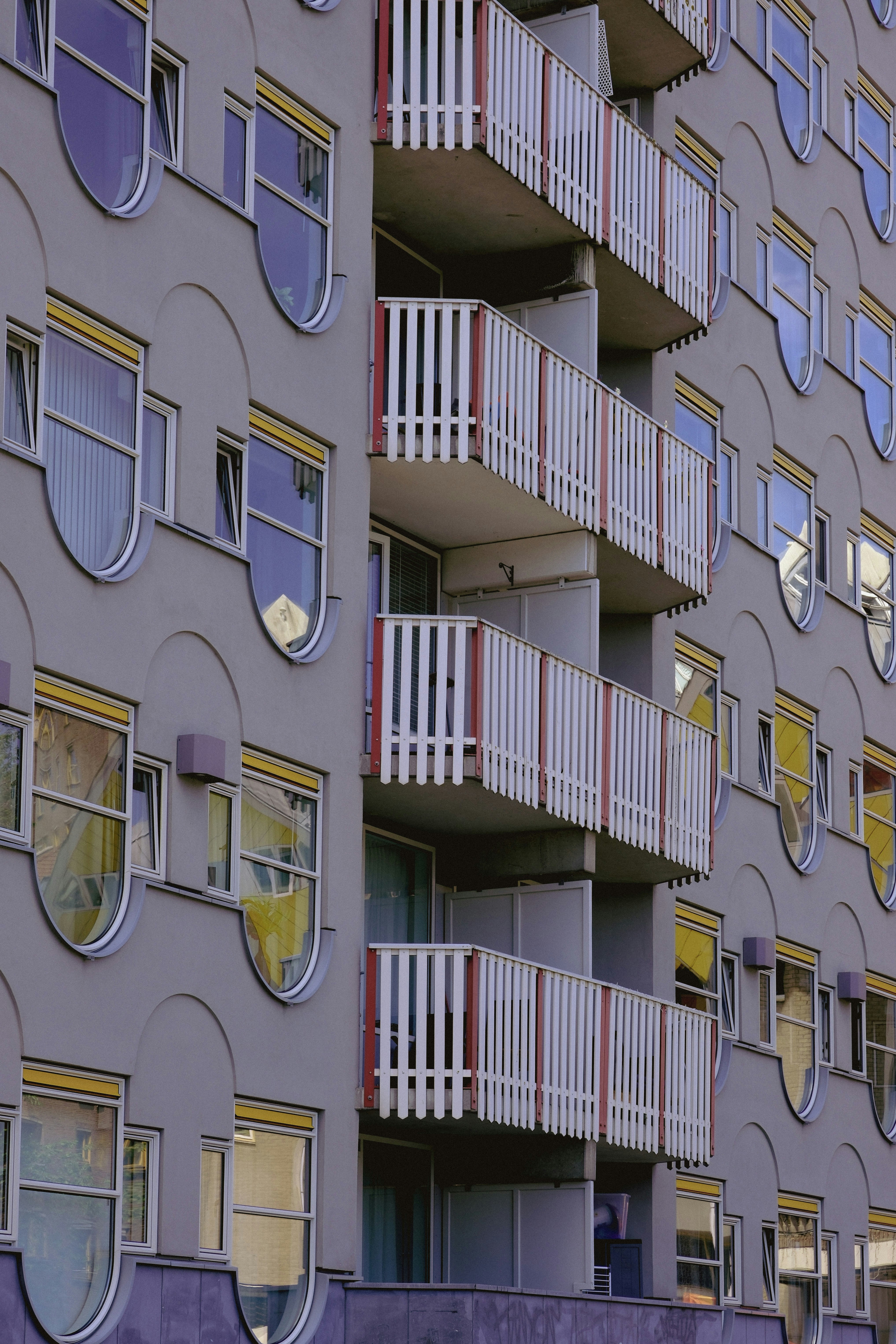 Modern gray apartment building with balconies and unique windows