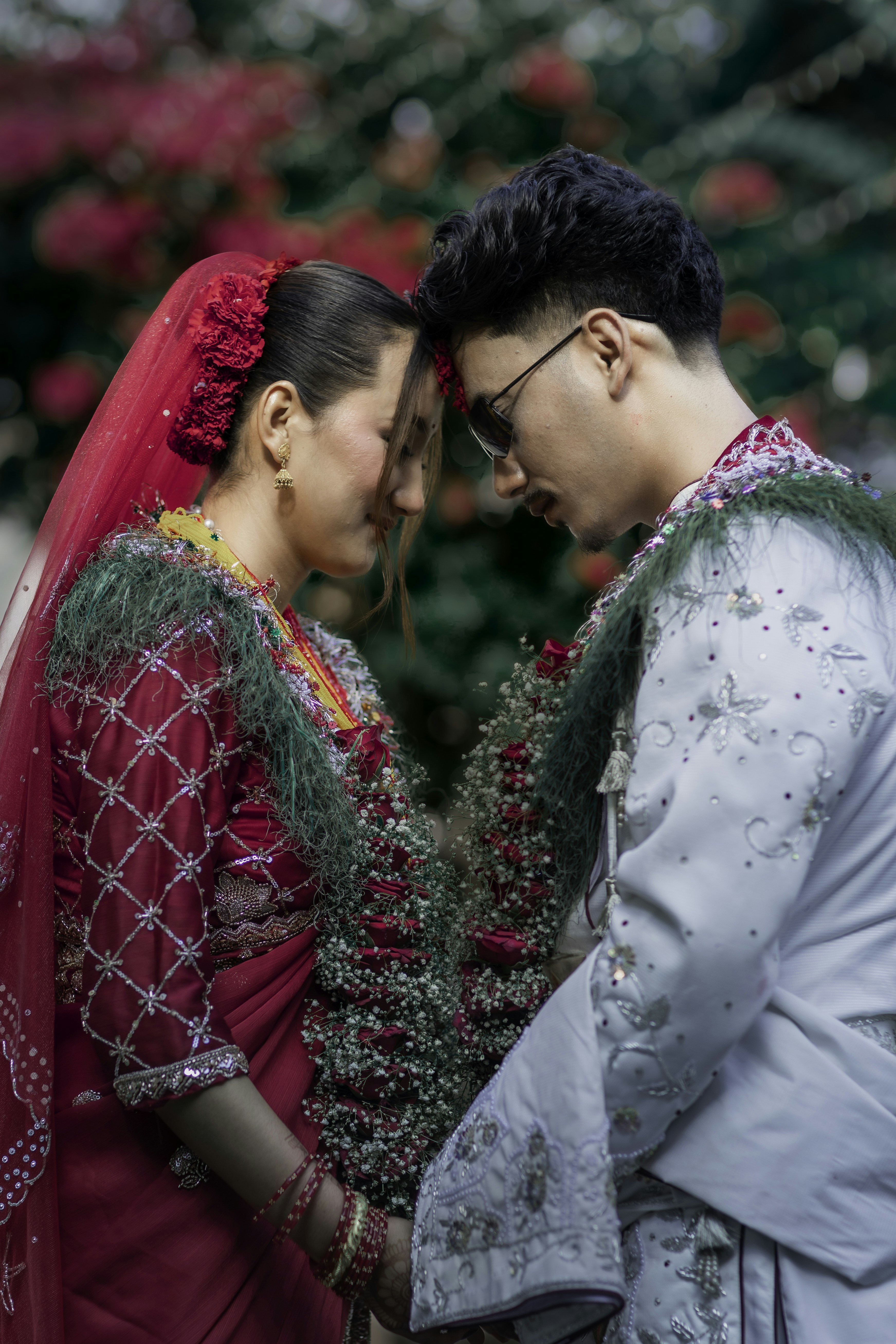 Couple in traditional wedding attire with foreheads touching - Free ...