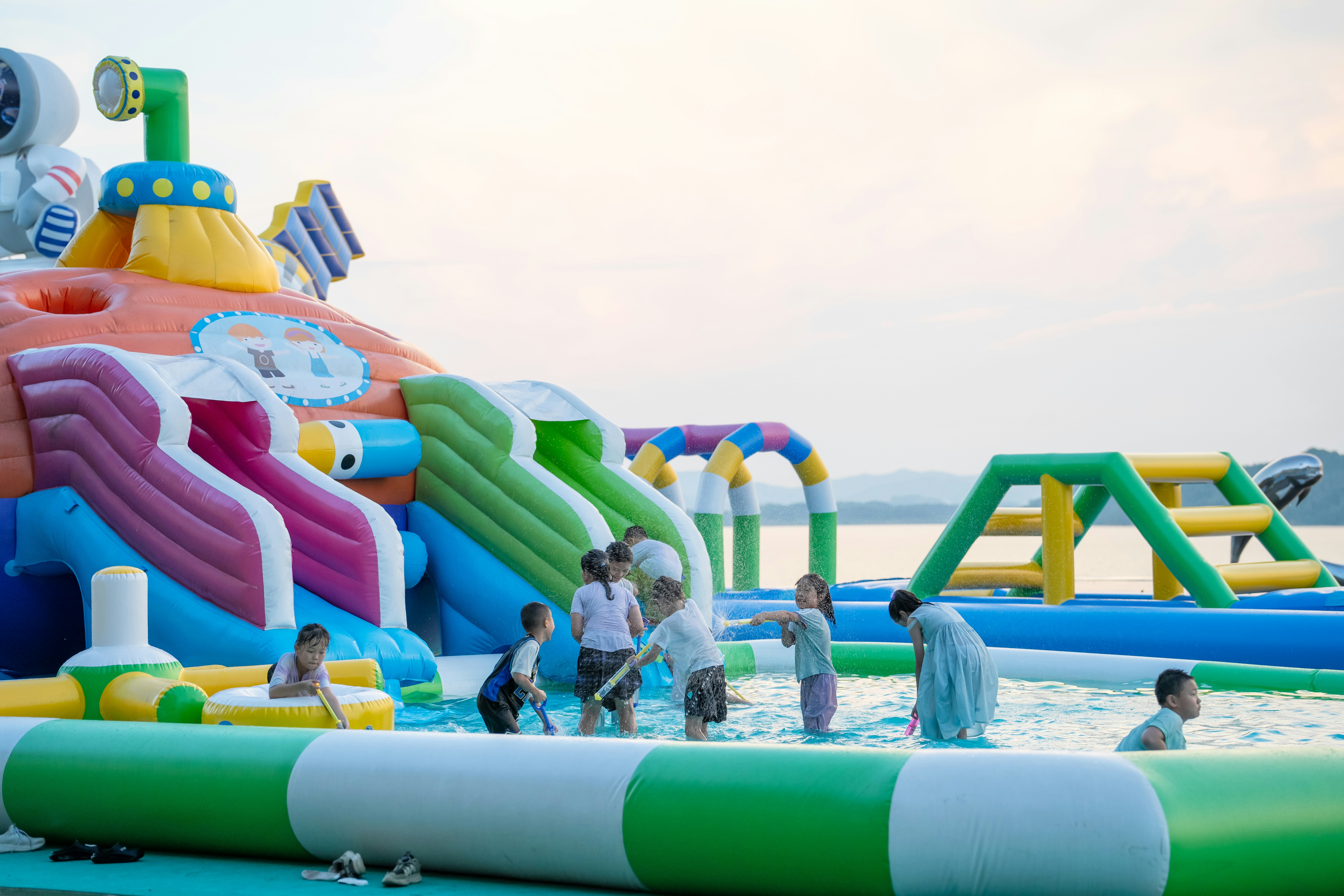 A large multi-part inflatable with a slide and bounce area