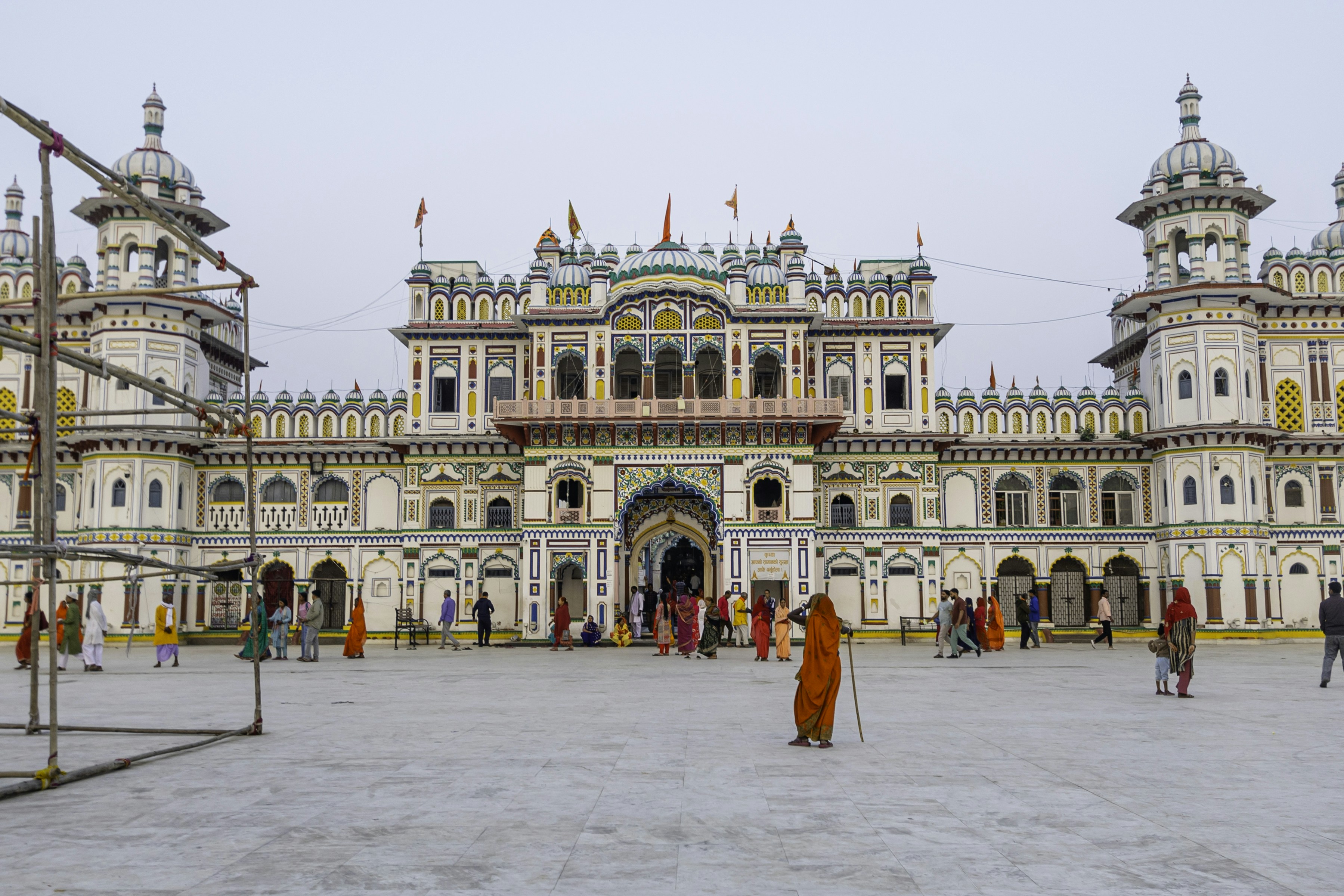 Ornate temple with people gathered in a large open area.
