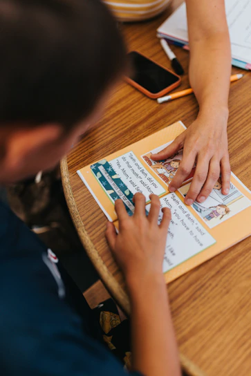 Two people learning together at a wooden table
