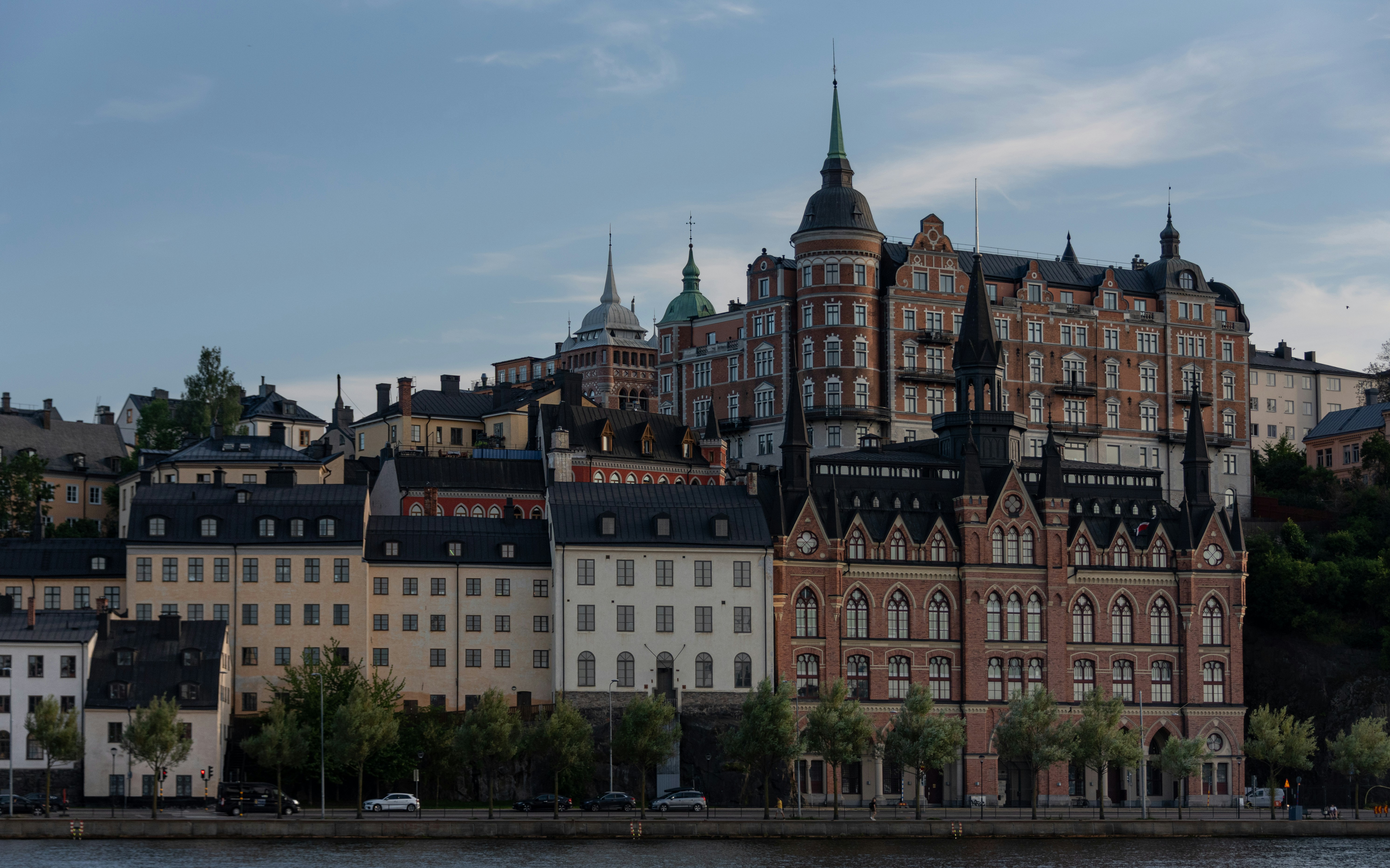 Historic buildings line the waterfront of a european city.