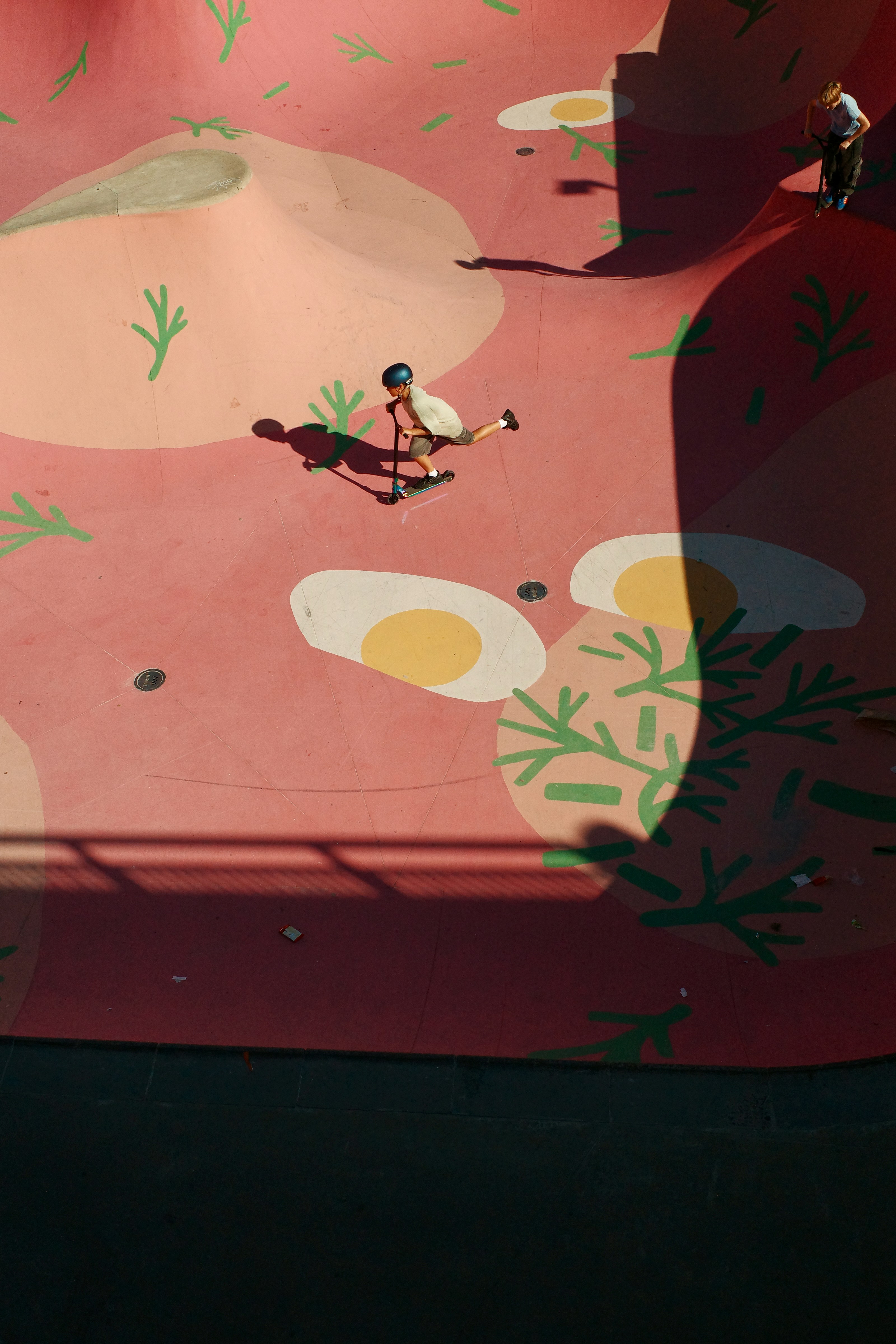 Scooter rider in a pink skatepark with egg designs