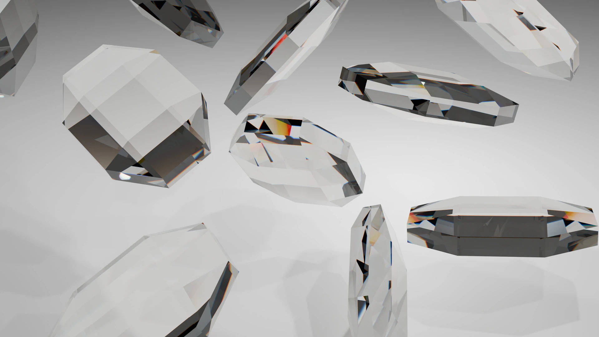 Multiple clear, faceted crystal shapes floating against a light background