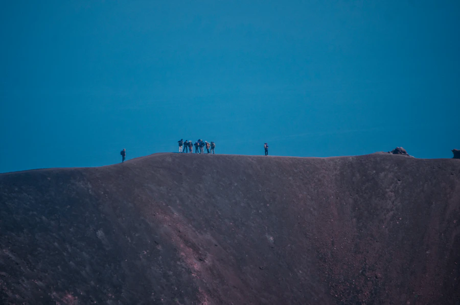 Explorers standing on a volcanic mountain