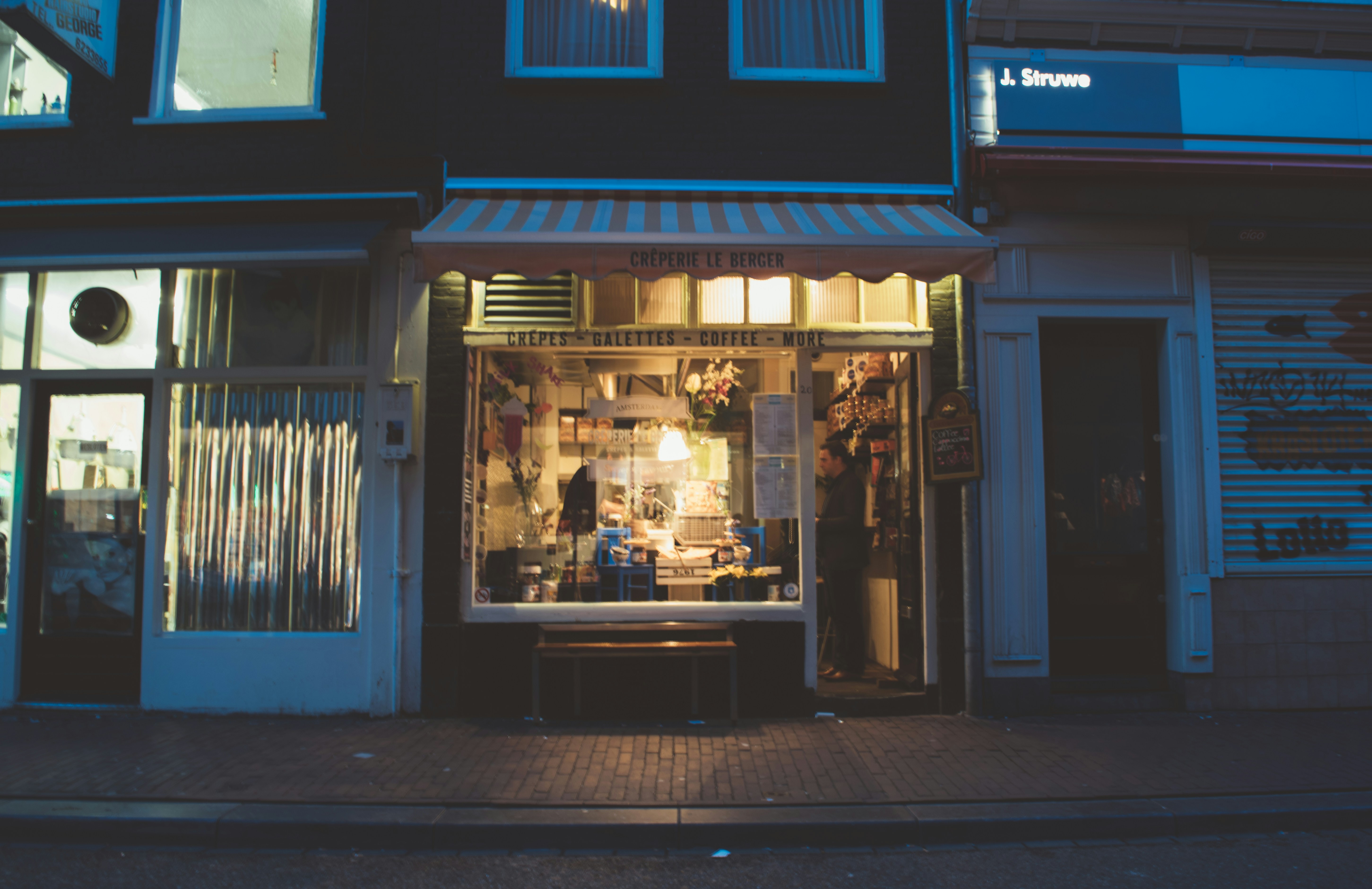 Brightly lit shopfront at night
