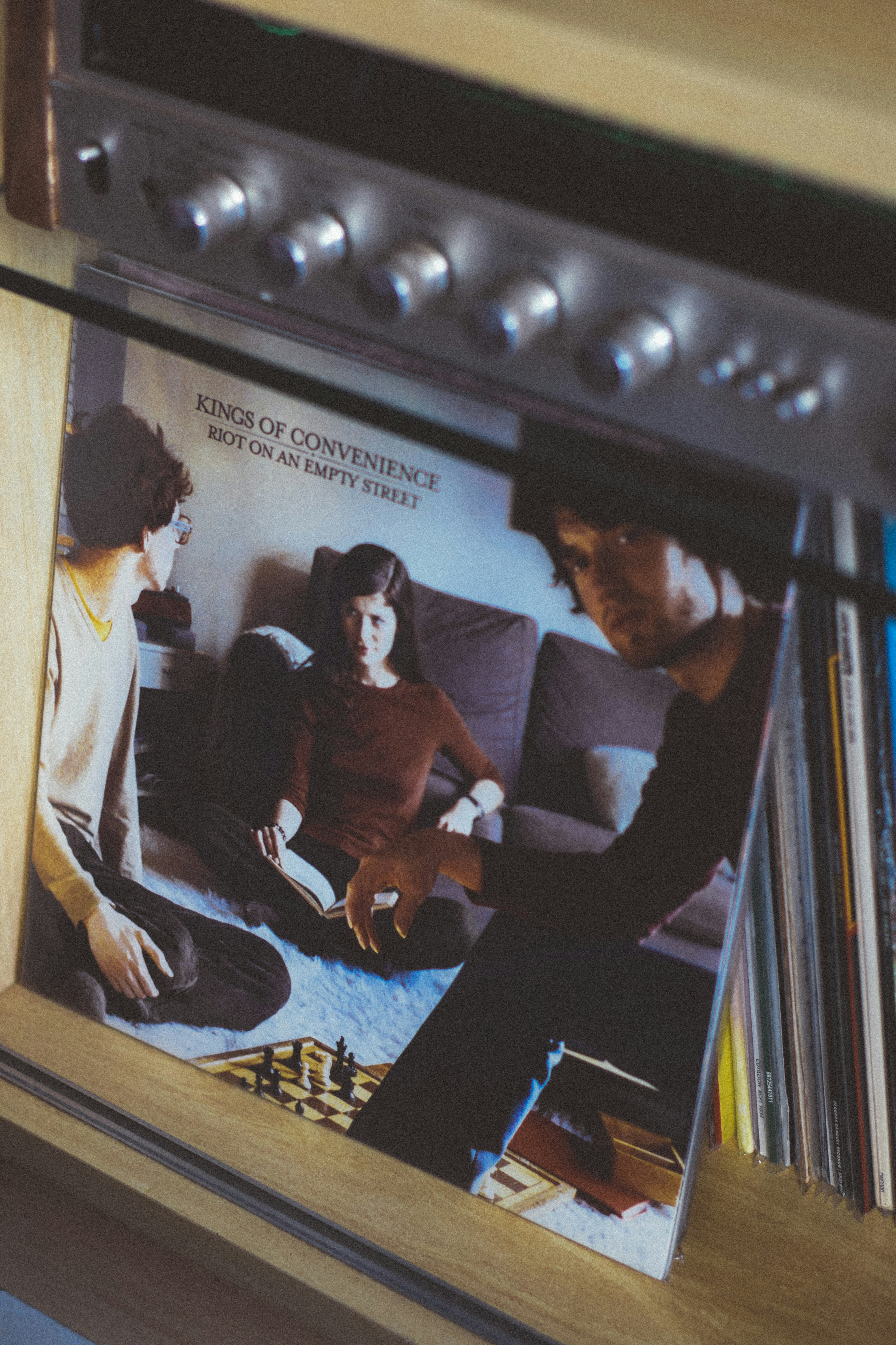 Kings of convenience vinyl album cover on a shelf.