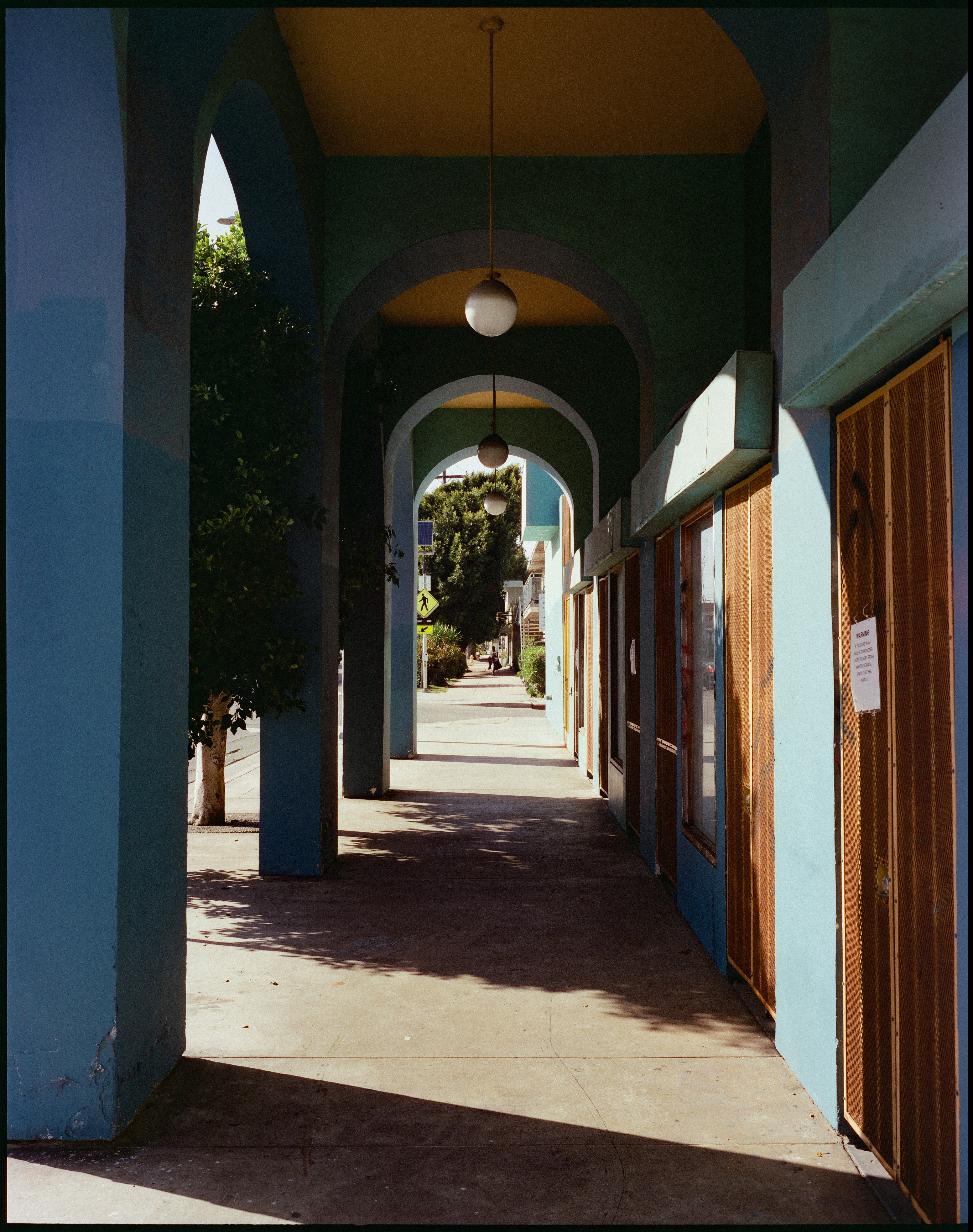 Teal arched walkway with wooden doors in los angeles
